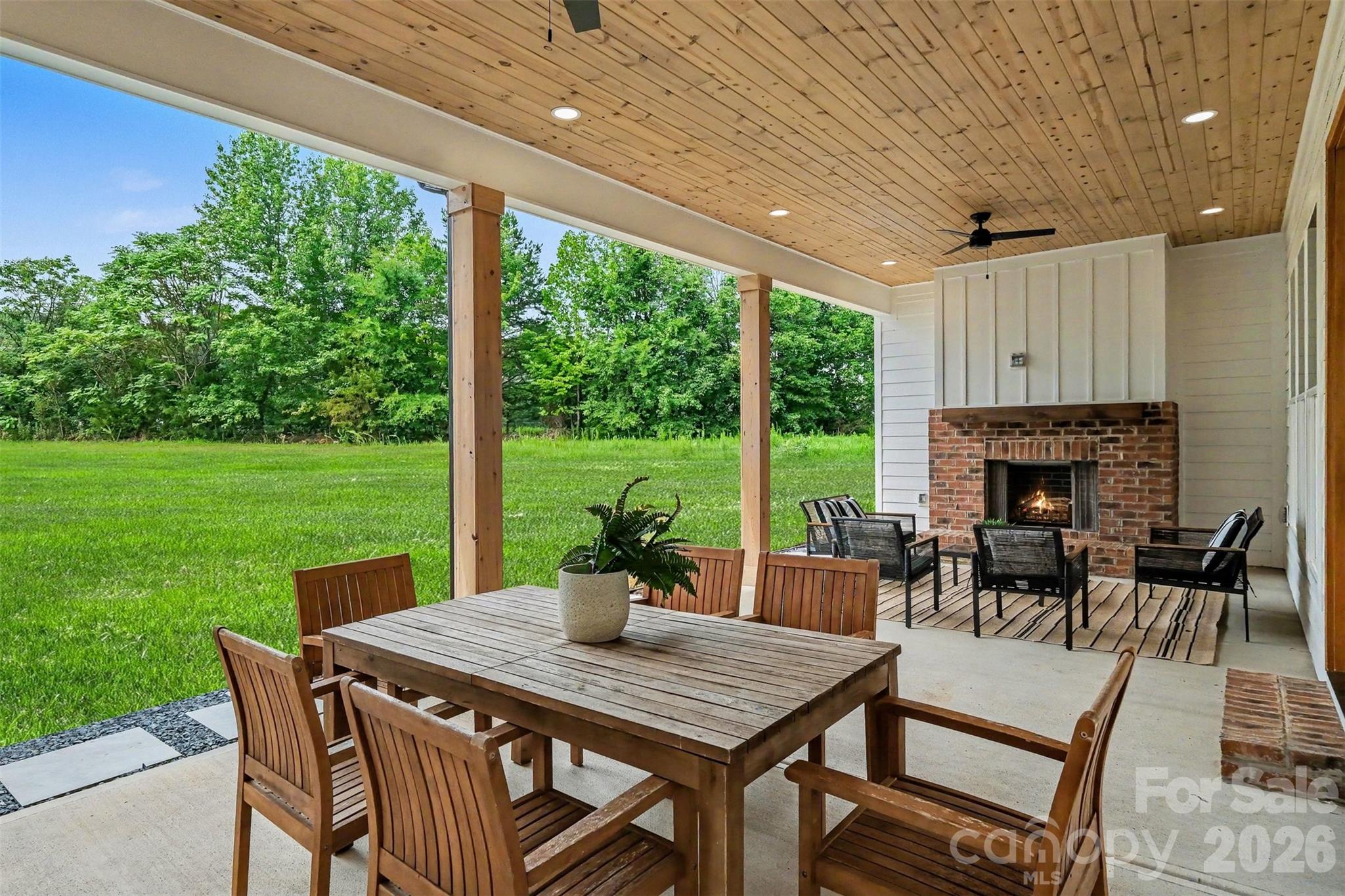 Perhaps the coolest feature of this home is the 31-foot covered back porch that overlooks your amazing 2-acre lot. - 6609 McNeely Road, Waxhaw