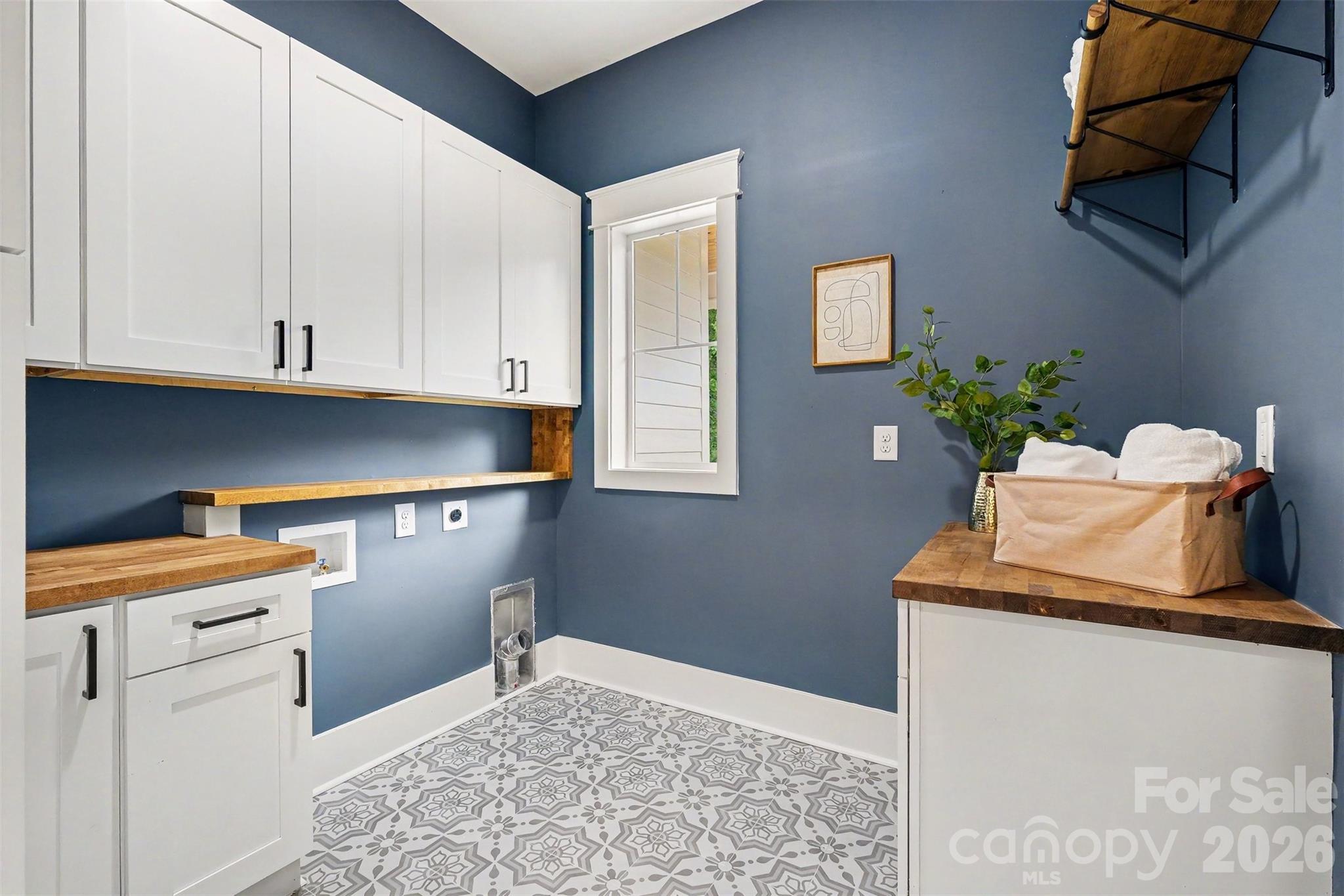 Among the coolest parts of this home is the BEST laundry room you've ever seen -- tons of cabinets AND multiple folding counters. - 6609 McNeely Road, Waxhaw