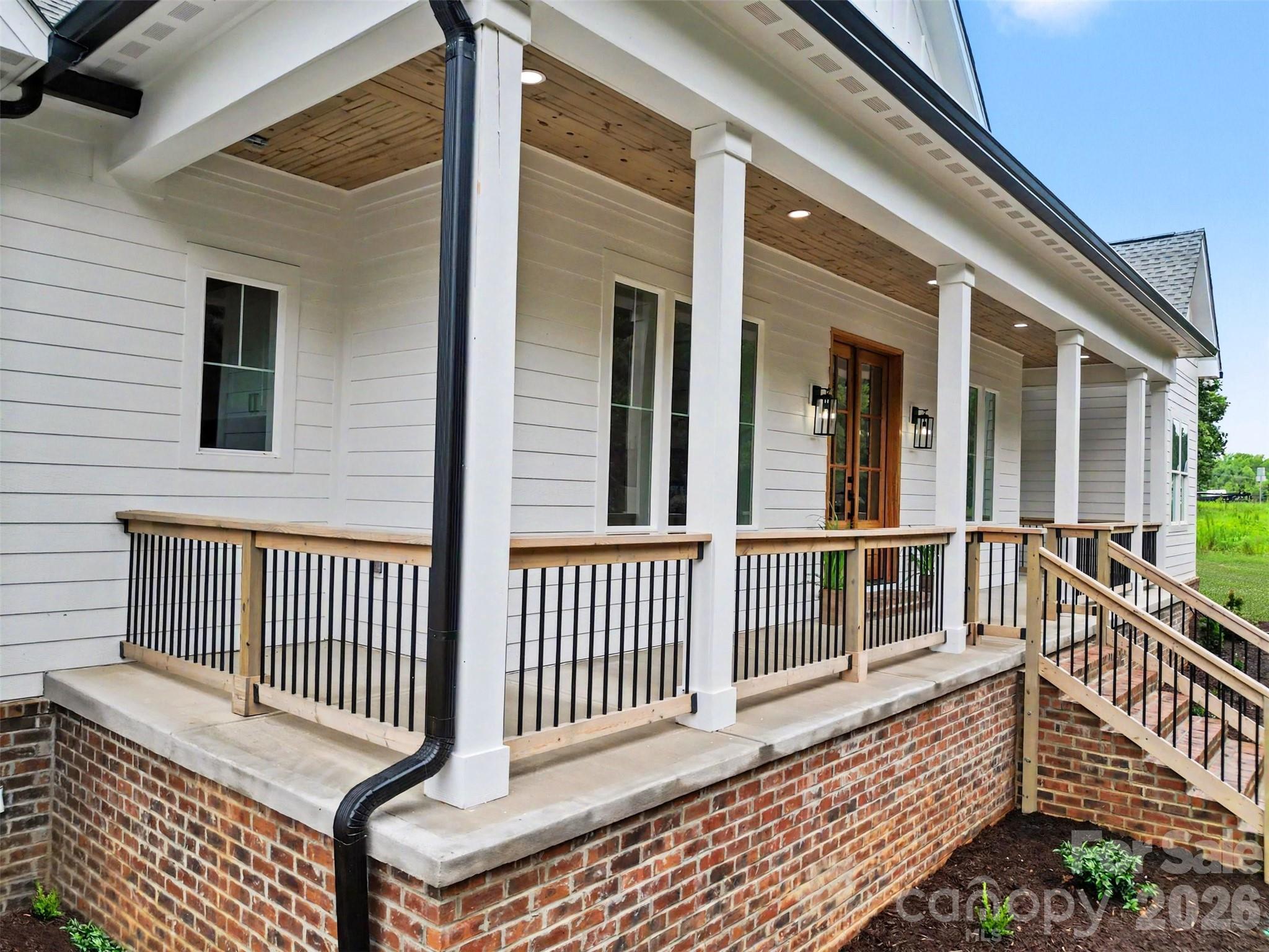 You'll greet your friends and family on your 32-foot covered front porch. - 6609 McNeely Road, Waxhaw