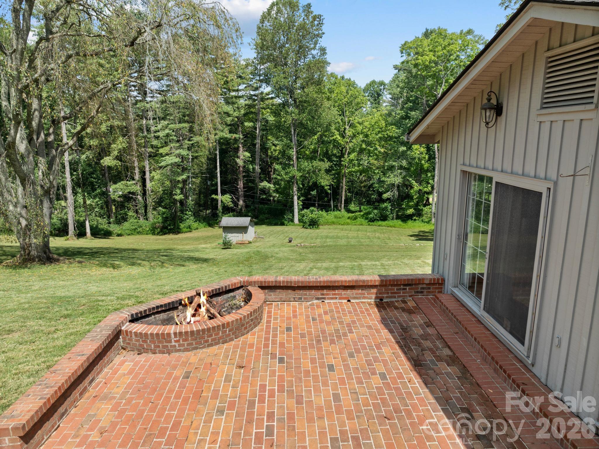 Brick patio overlooking the yard. - 242 N Hills Drive, Hendersonville