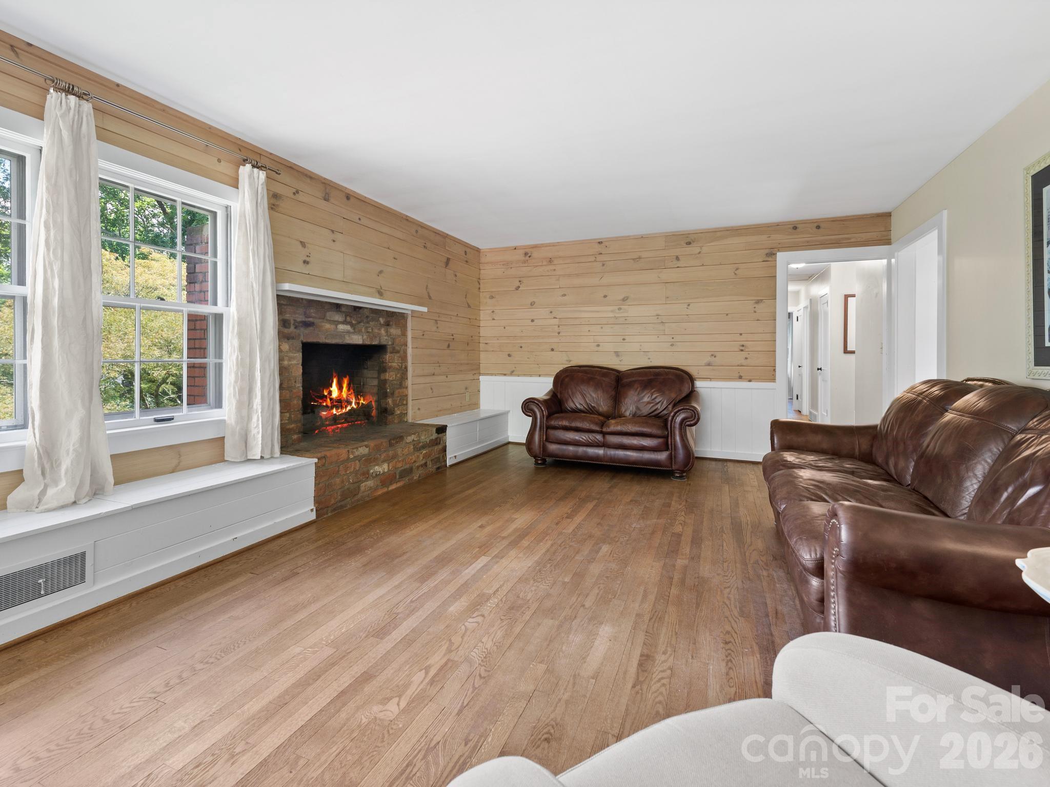 Family room with HWF's & knotty pine accent walls. - 242 N Hills Drive, Hendersonville