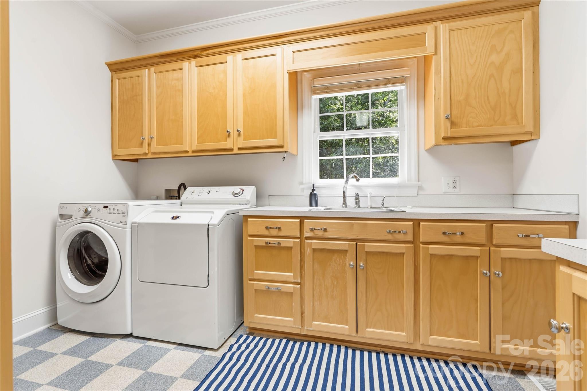 The built-in cabintry, along with the extra sink, makes doing laundry a sinch - 675 Heather Drive, Lincolnton
