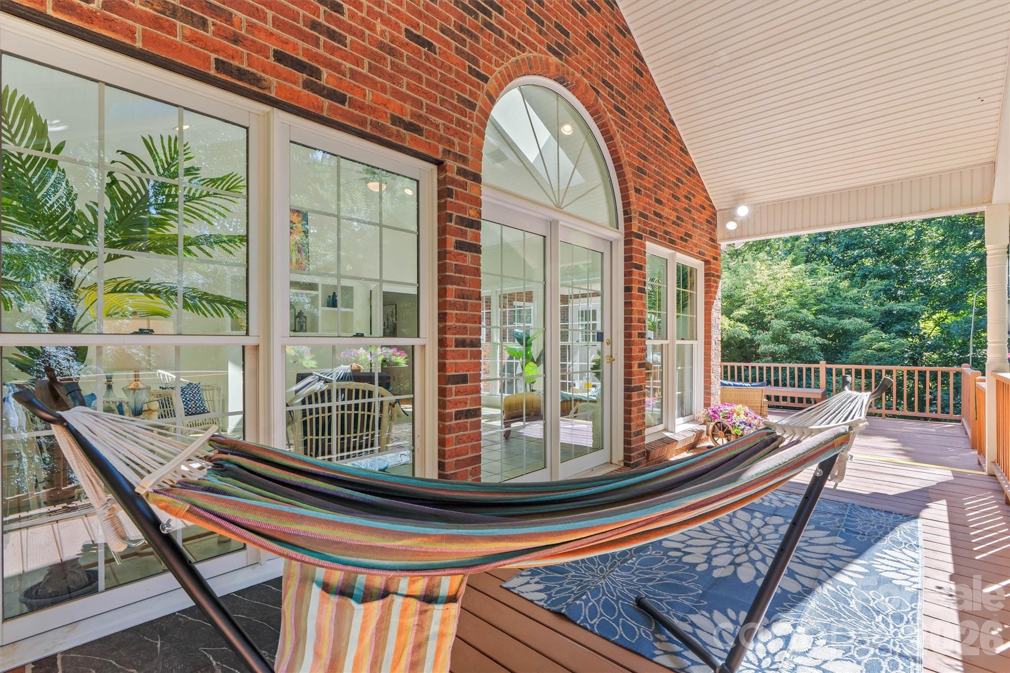 Outdoors, off the sunroom, enjoy this covered area overlooking your priate backyard. - 675 Heather Drive, Lincolnton