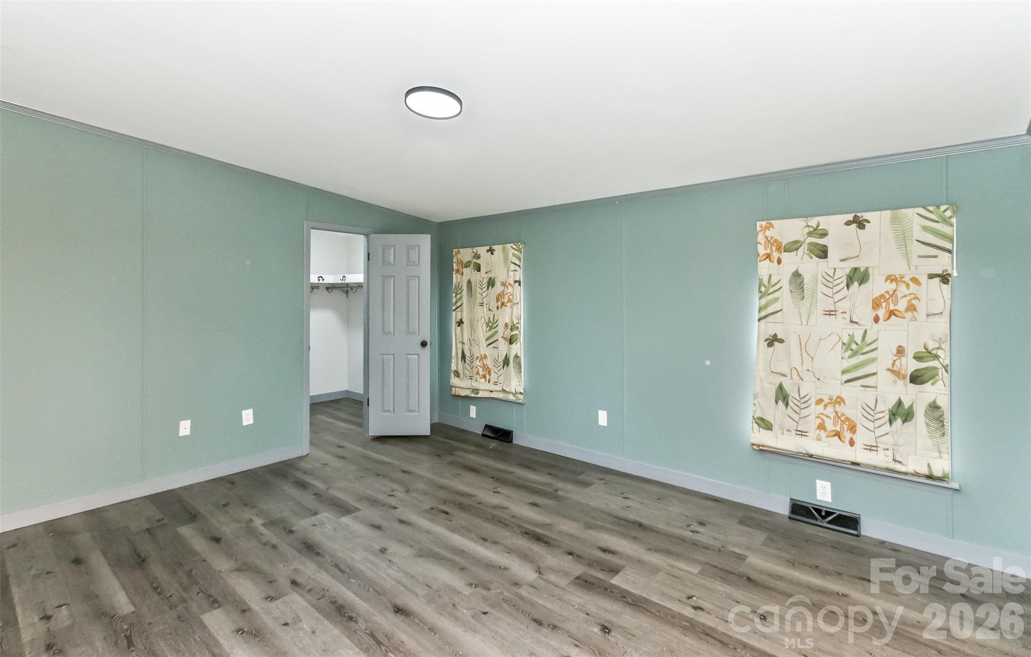 Primary bedroom with view toward walk-in closet - 25 Asa Court, Black Mountain