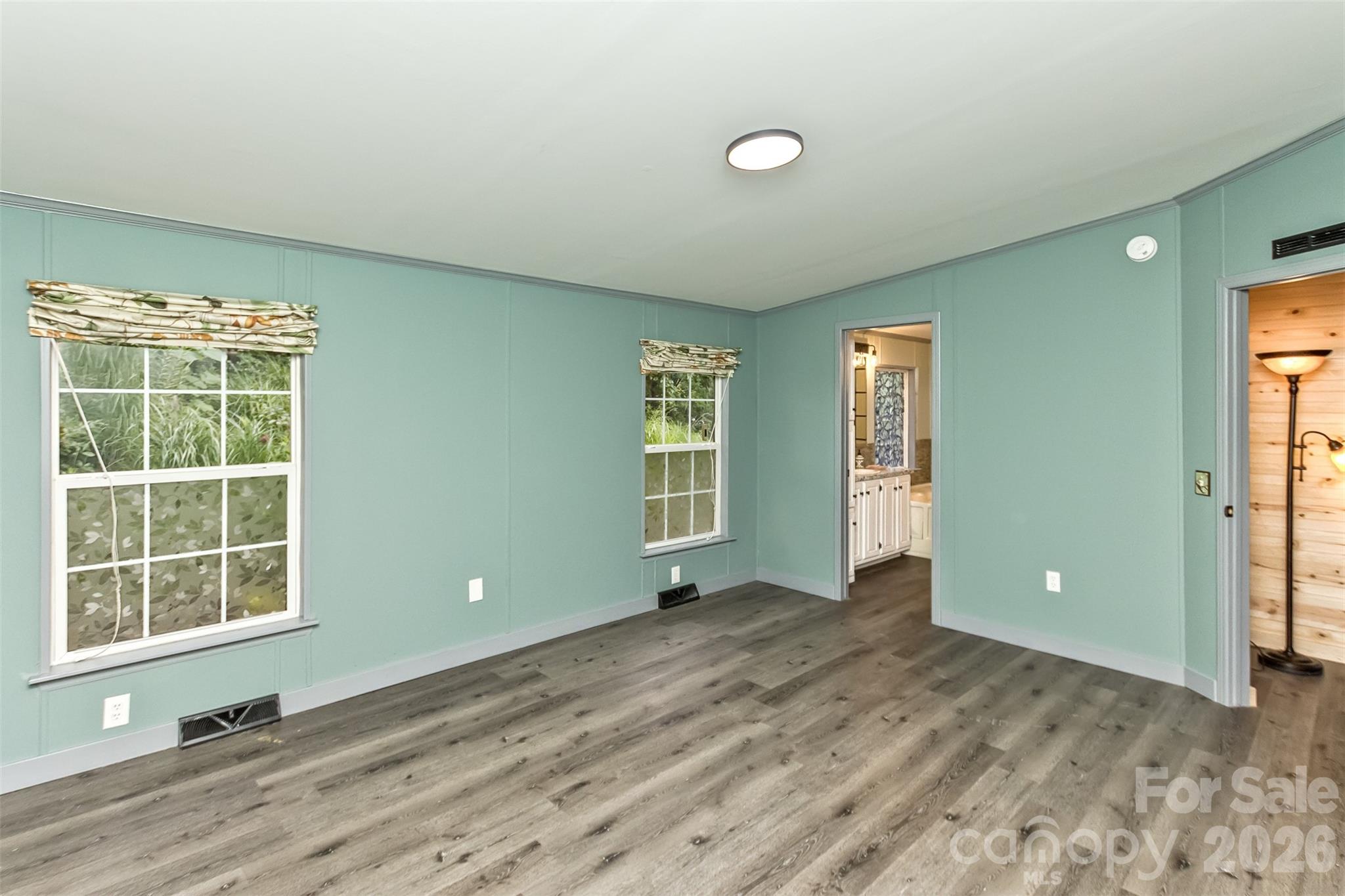 Primary bedroom with view toward en-suite bath and door to living room - 25 Asa Court, Black Mountain