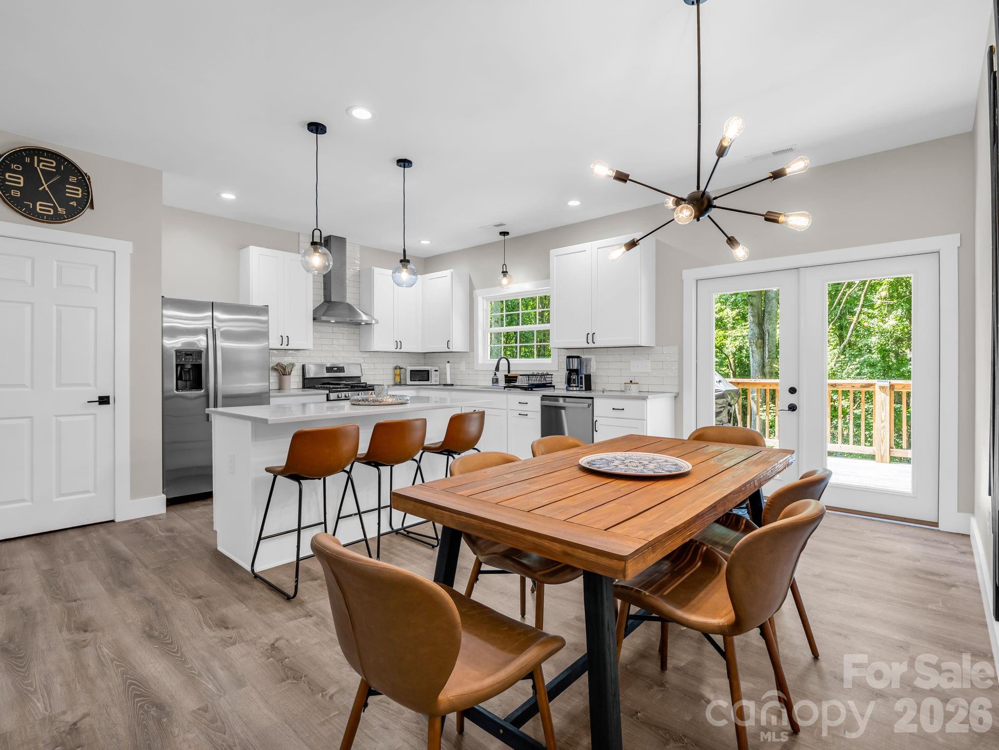 Like new stainless steel appliances convey. The door on the left is the pantry. - 180 Ridgeview Drive, Hendersonville