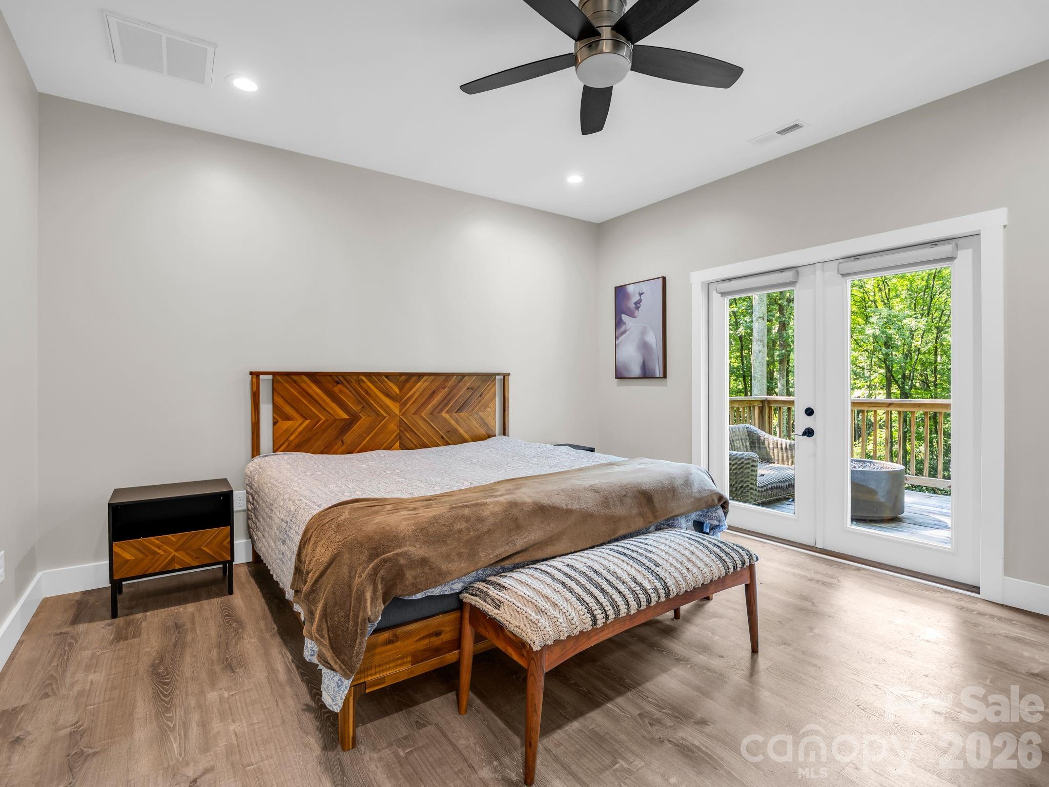 Primary bedroom with access to the back deck. - 180 Ridgeview Drive, Hendersonville