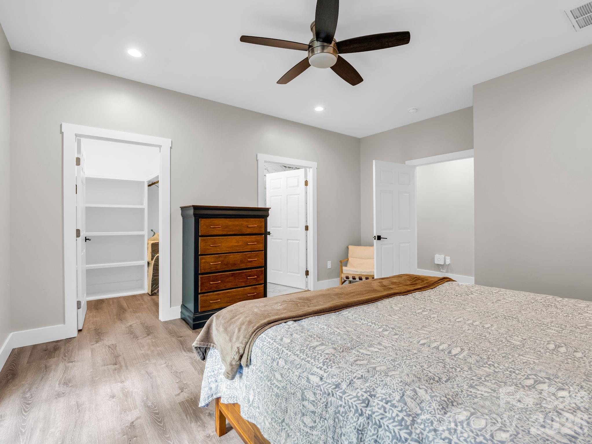 Primary bedroom, the walk-in closet is on the left and the primary bath is the door on the right. - 180 Ridgeview Drive, Hendersonville