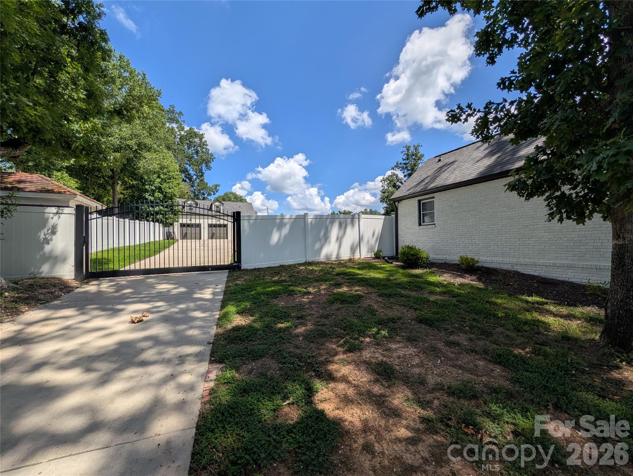 Entrance drive at left from the street, double detached garage visible at left rear. There is an older, one BR, one BA apartment atop garage, older build, would need a remodel, but has much potential! - 276 N 4th Street N, Albemarle