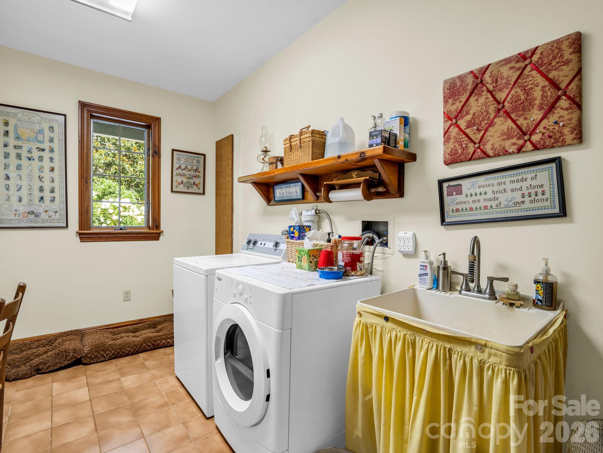 Laundry room with sink, ironing board, door to garage and to back deck - 15 Ravenwood Drive, Fletcher