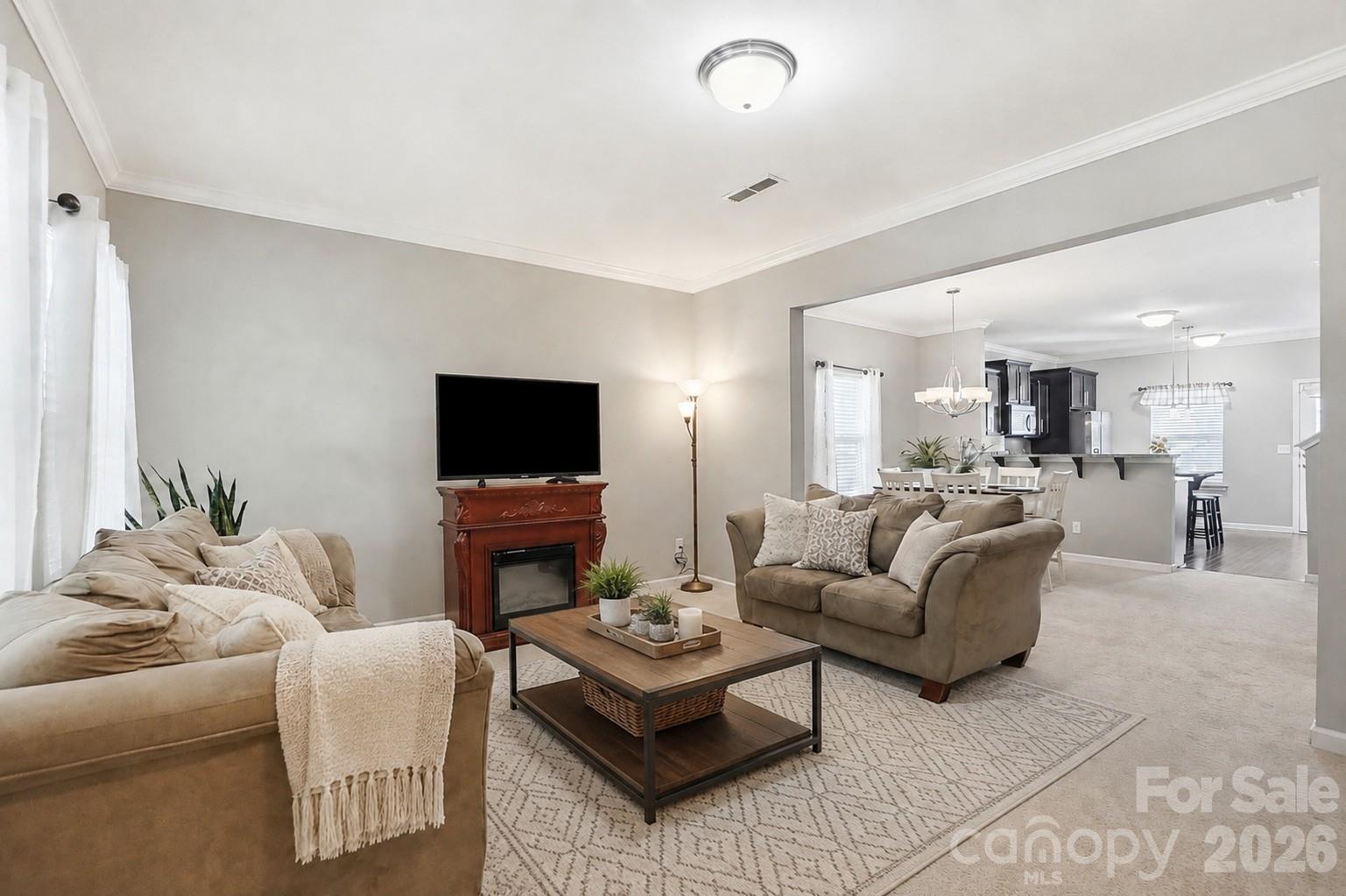The family room flows seamlessly into the dining area and kitchen. - 11608 Galashiels Drive, Huntersville