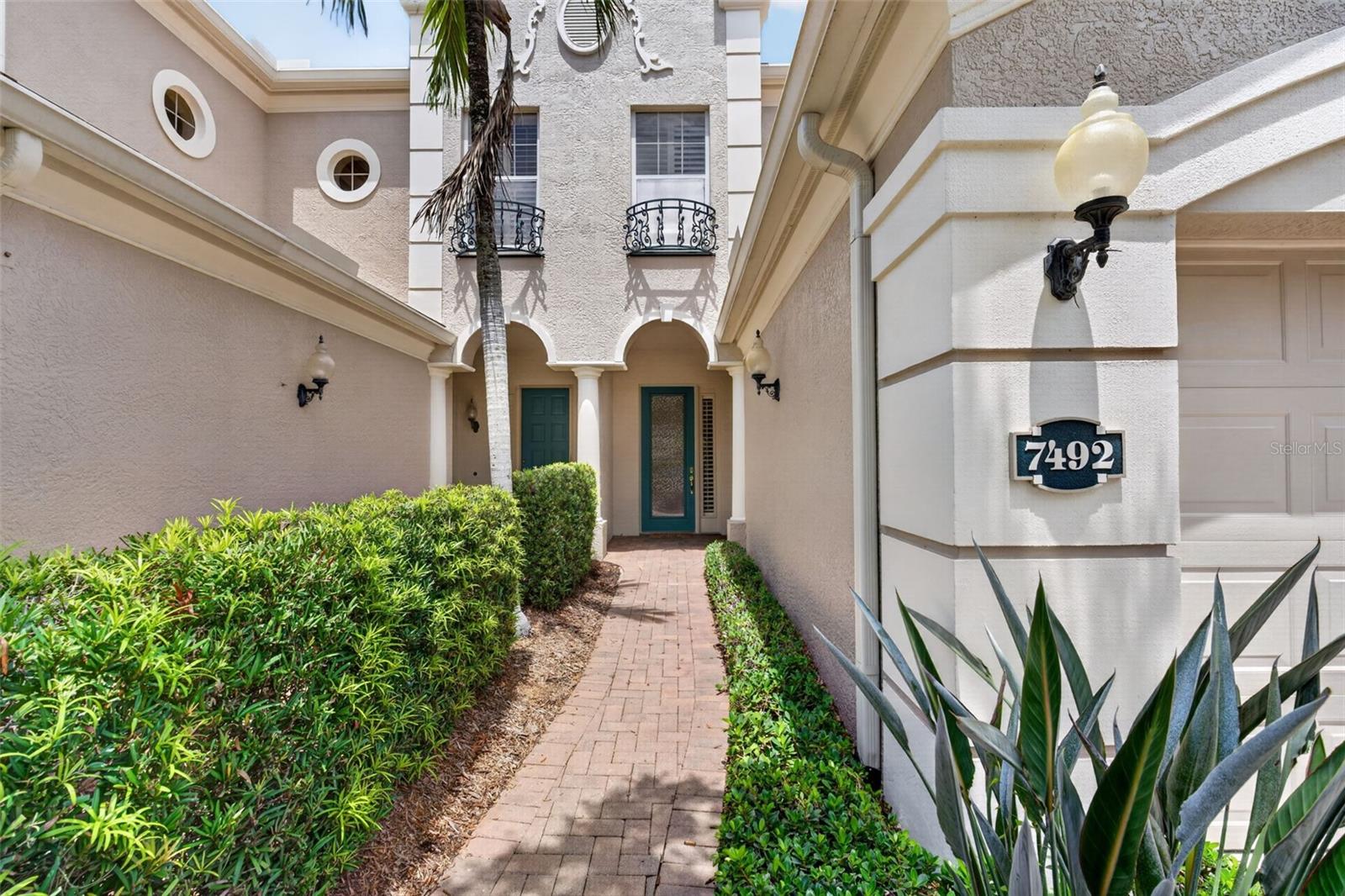 Paved entry pathway to the front door - 7492 BOTANICA PKWY #102, SARASOTA