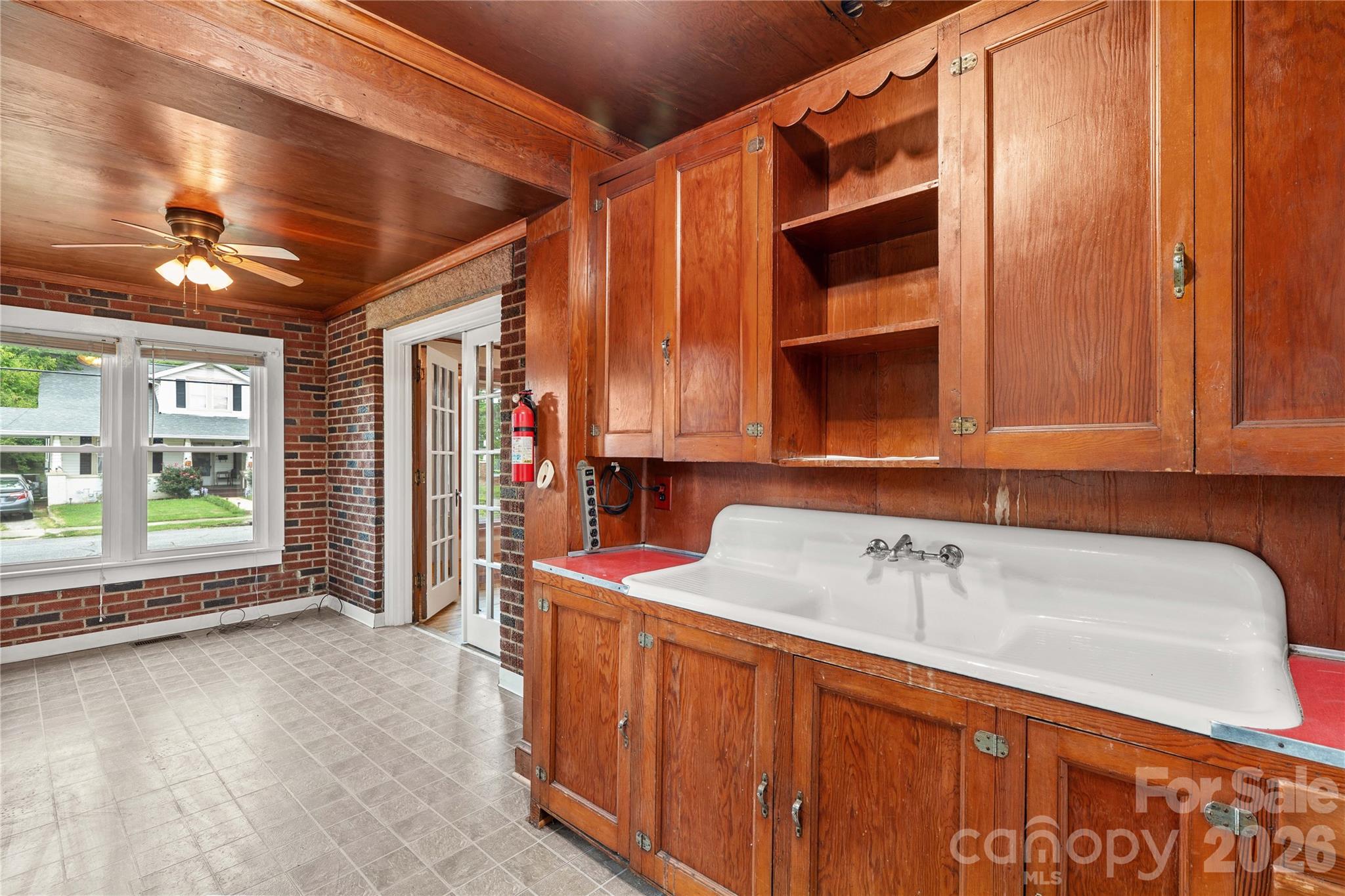 Cool old porcelain farmhouse sind and cabinetry in utility/sunroom. - 615 S Church Street, Salisbury