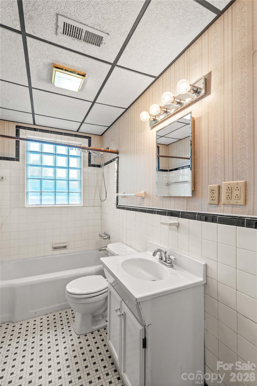 Upstairs full bath has tiled floors and porcelain bathtub. - 615 S Church Street, Salisbury