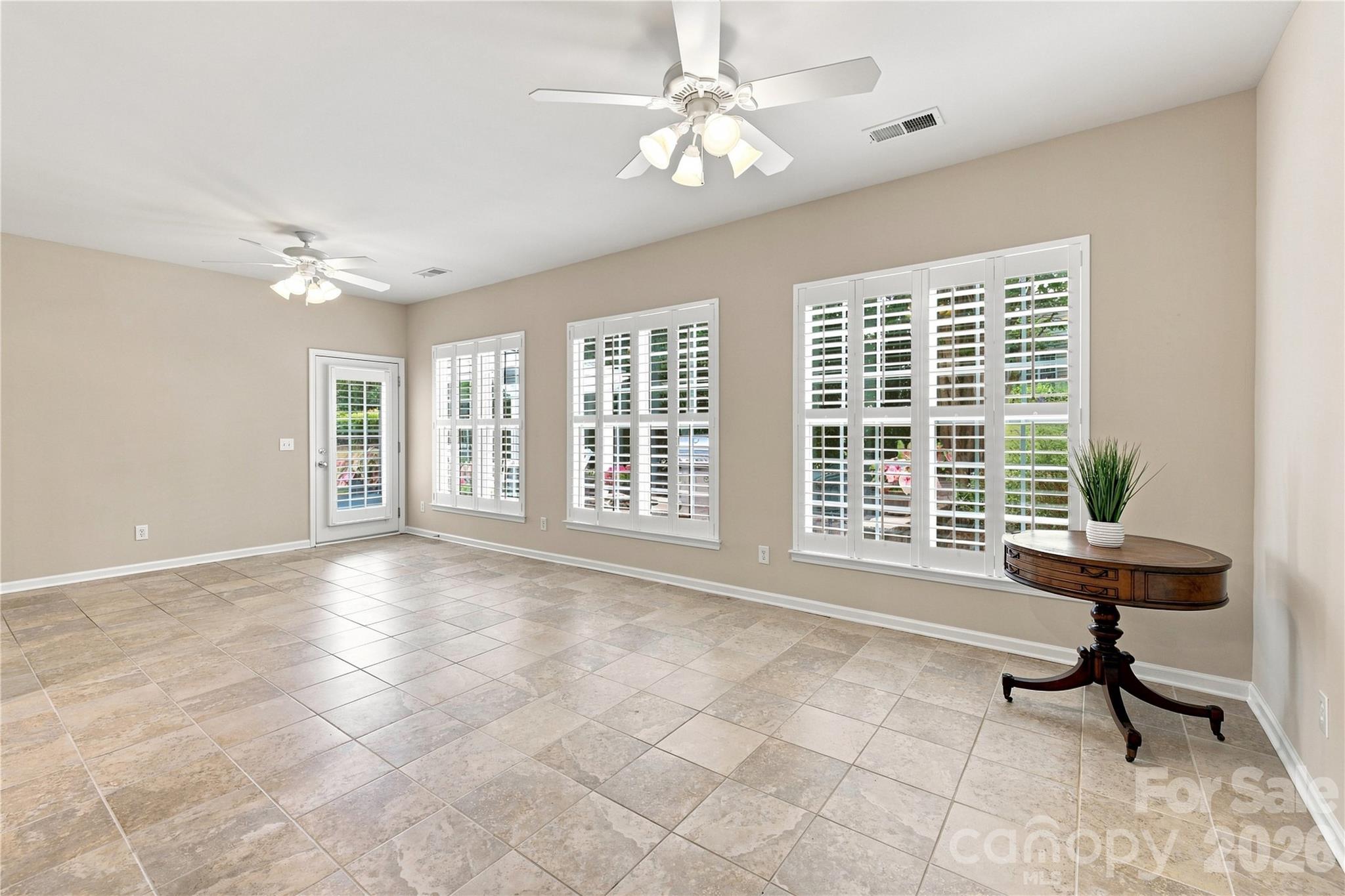 Sunroom overlooking the back patio, large windows, Plenty of Natural Light - 39650 Rosebay Court, Indian Land