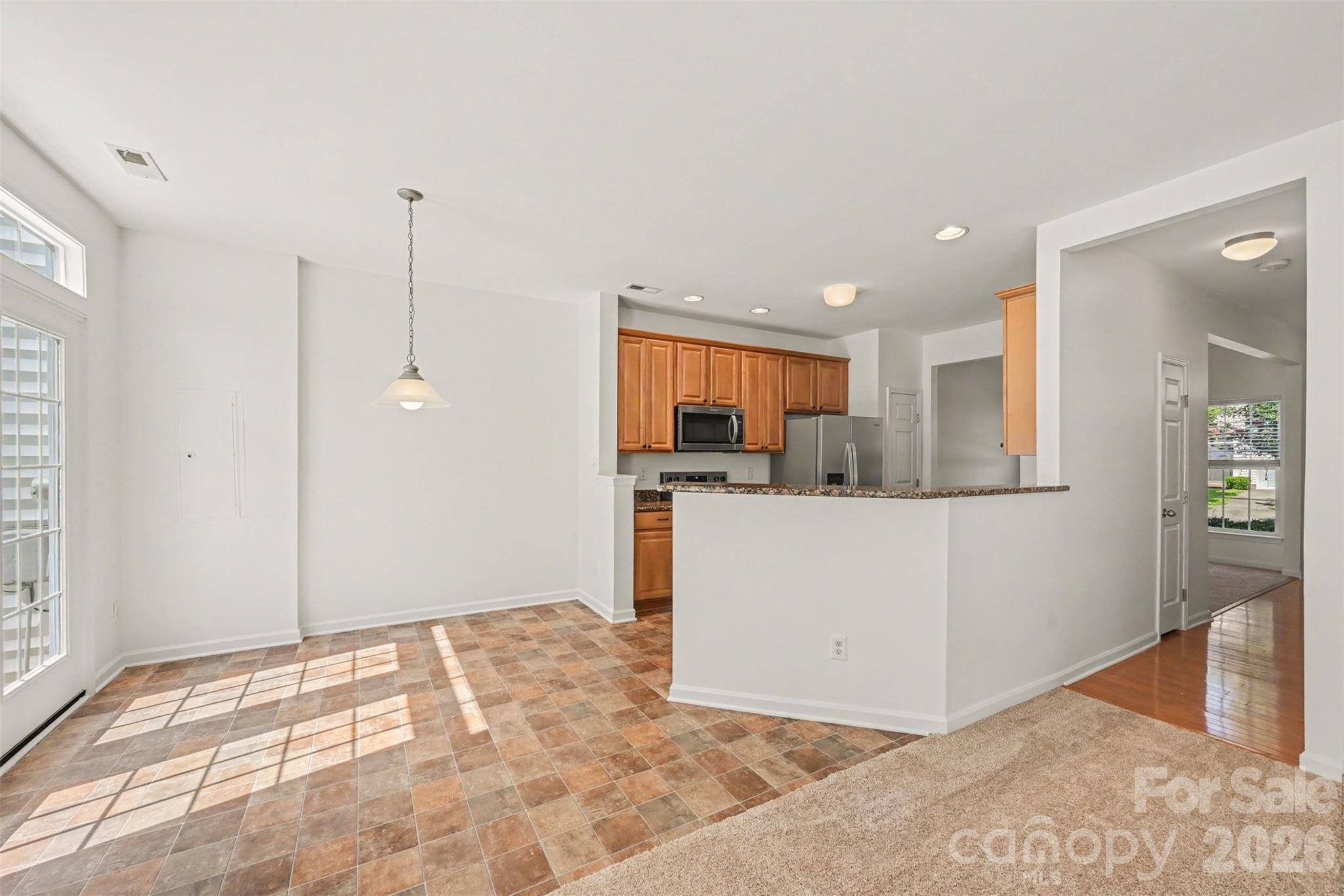 Well-lit breakfast area!  Enjoy beautiful view of tree-lined back yard from here. - 107 S Arcadian Way, Mooresville