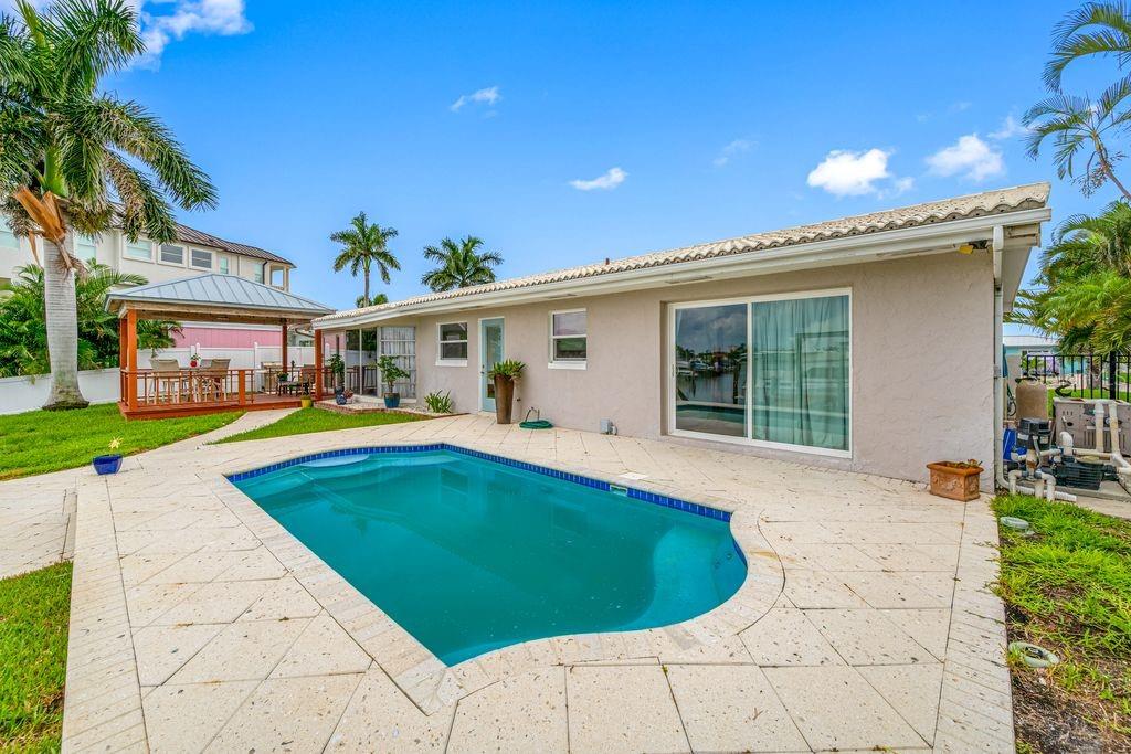 Pool with seashell pavers - Slider is access to primary suite - Covered deck off dining room - 530 79TH ST S, ST PETERSBURG