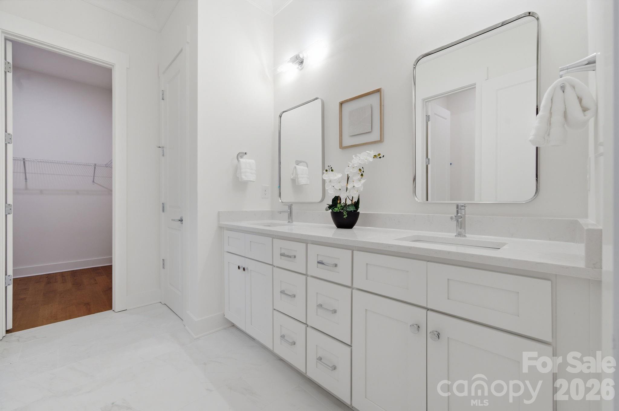 Luxurious primary bathroom with cohesive velvet white tile throughout - 612 Camelot Drive, Salisbury