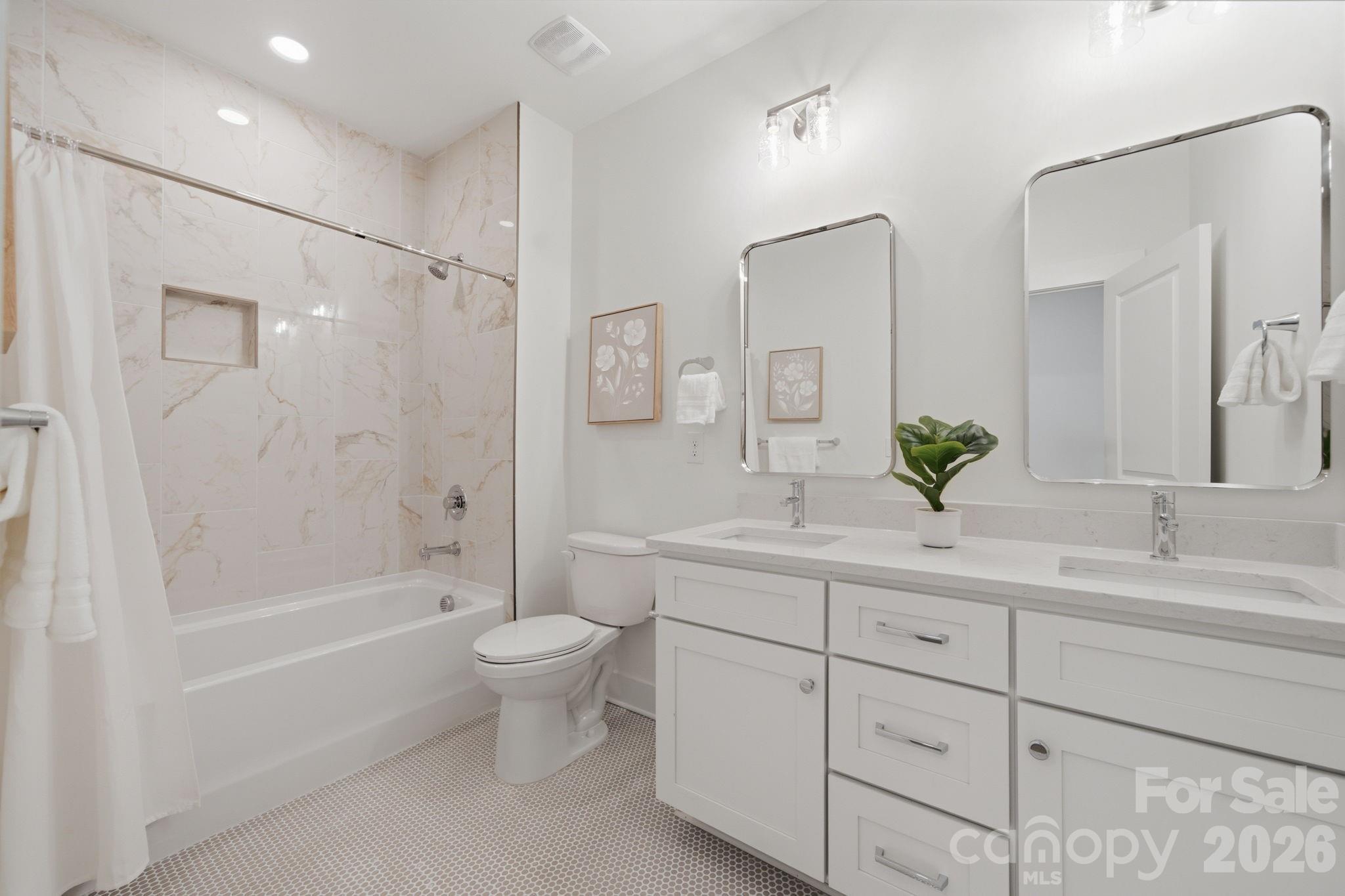 Upstairs Full Bath 2 of 2 featuring trendy taupe penny floors and stunning calacatta apuano polished shower tile - 612 Camelot Drive, Salisbury