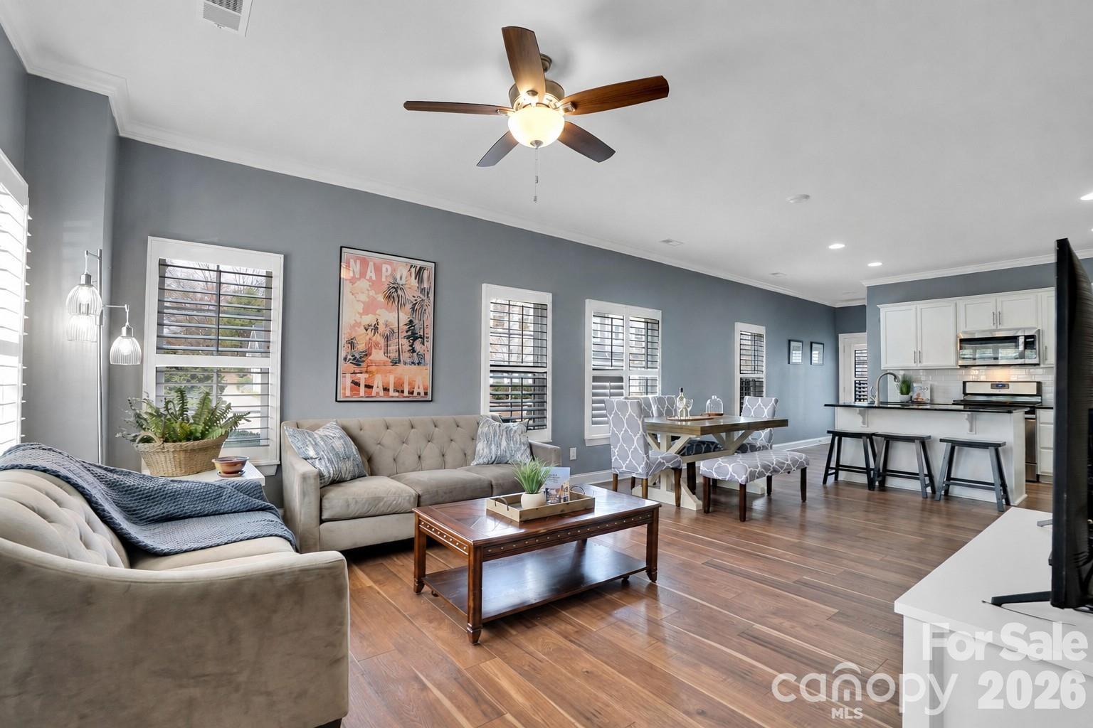 Open concept living room, dining and kitchen complete. Lots of windows with plantation shutters throughout! - 1178 Almerton Drive, Denver