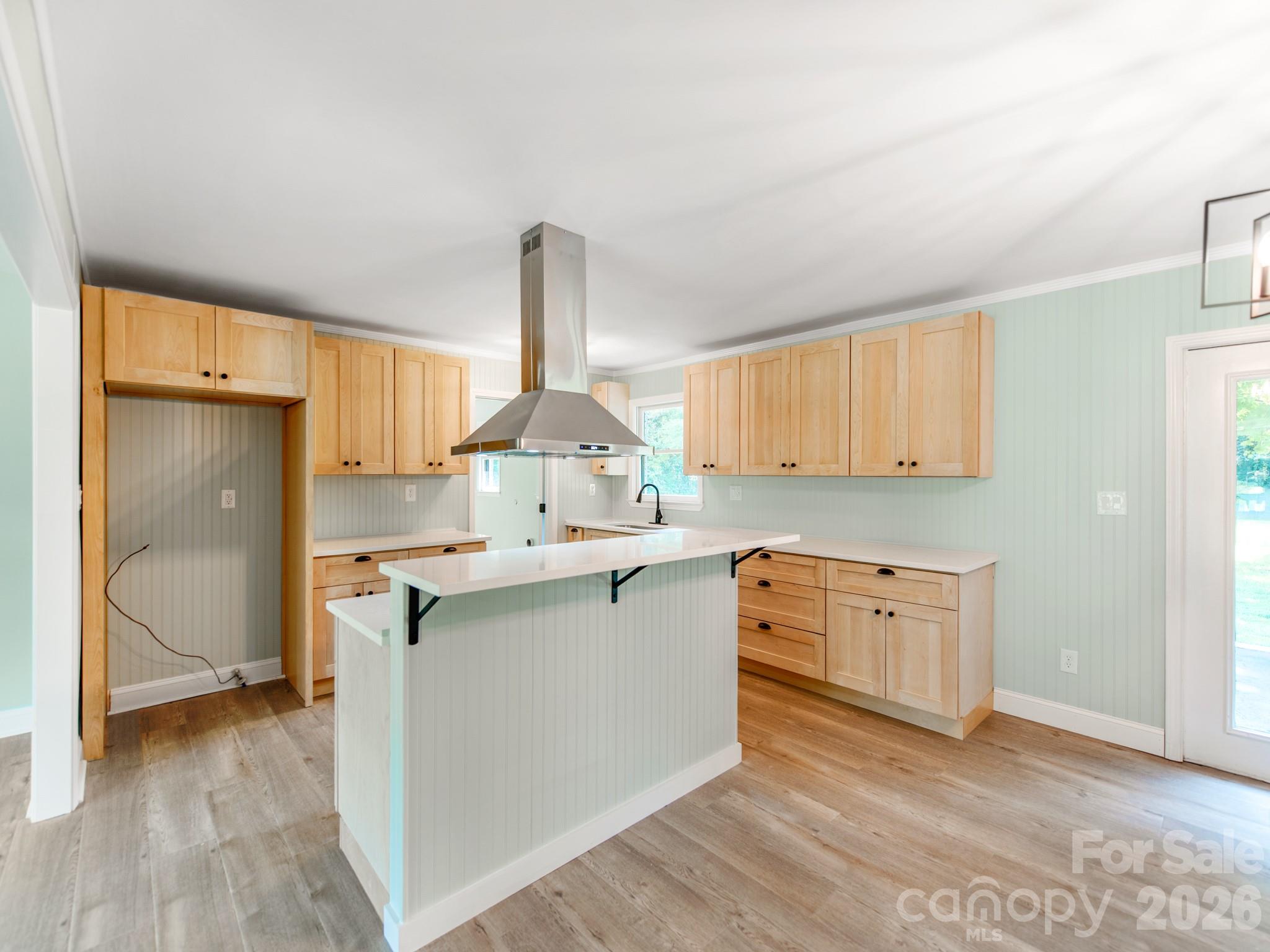 Kitchen island with new stove and vent hood - 3072 Bethany Street, Claremont