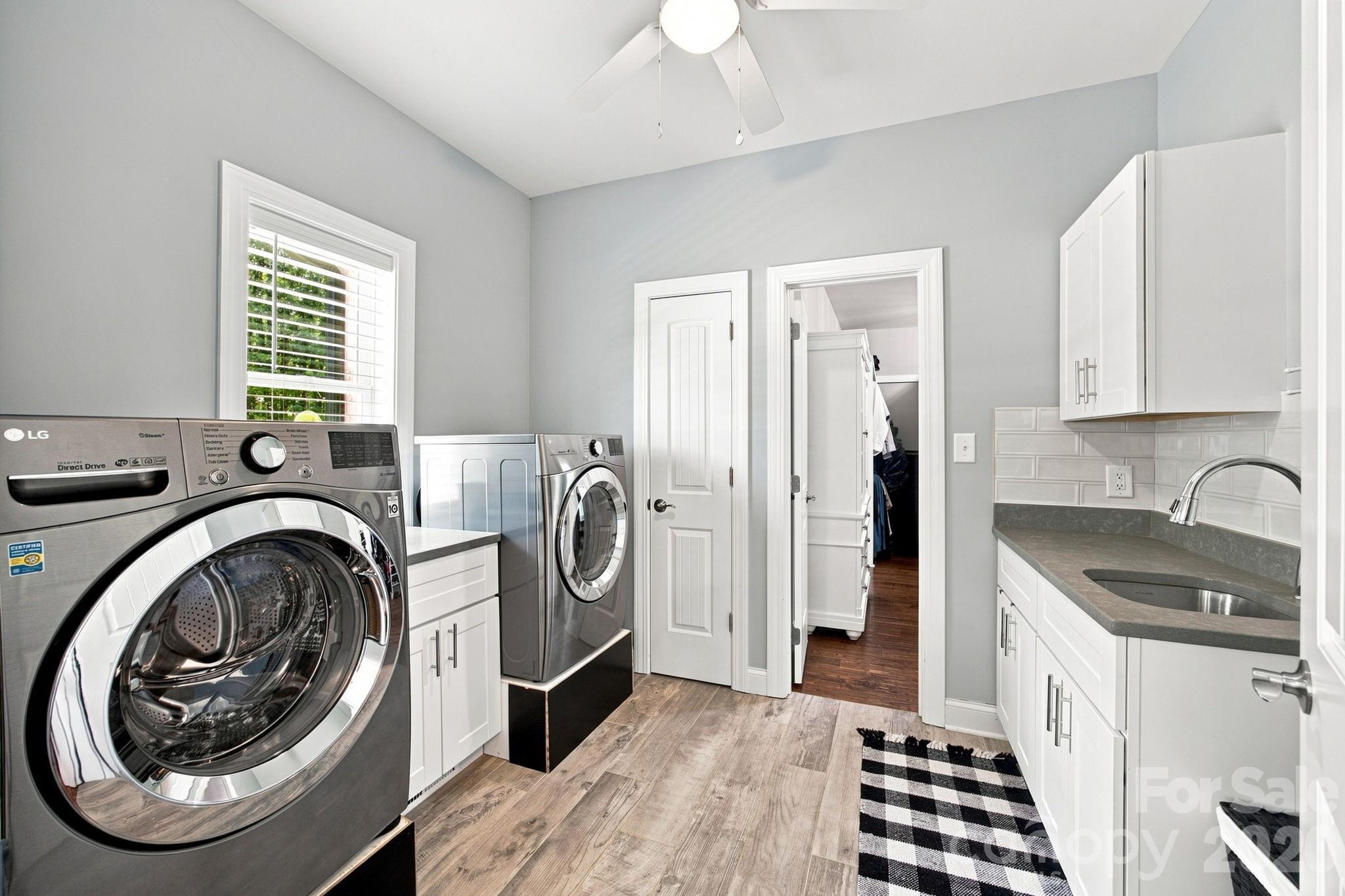 Laundry room connects primary closet and main hallway. - 116 Harbor Ridge Drive, Statesville
