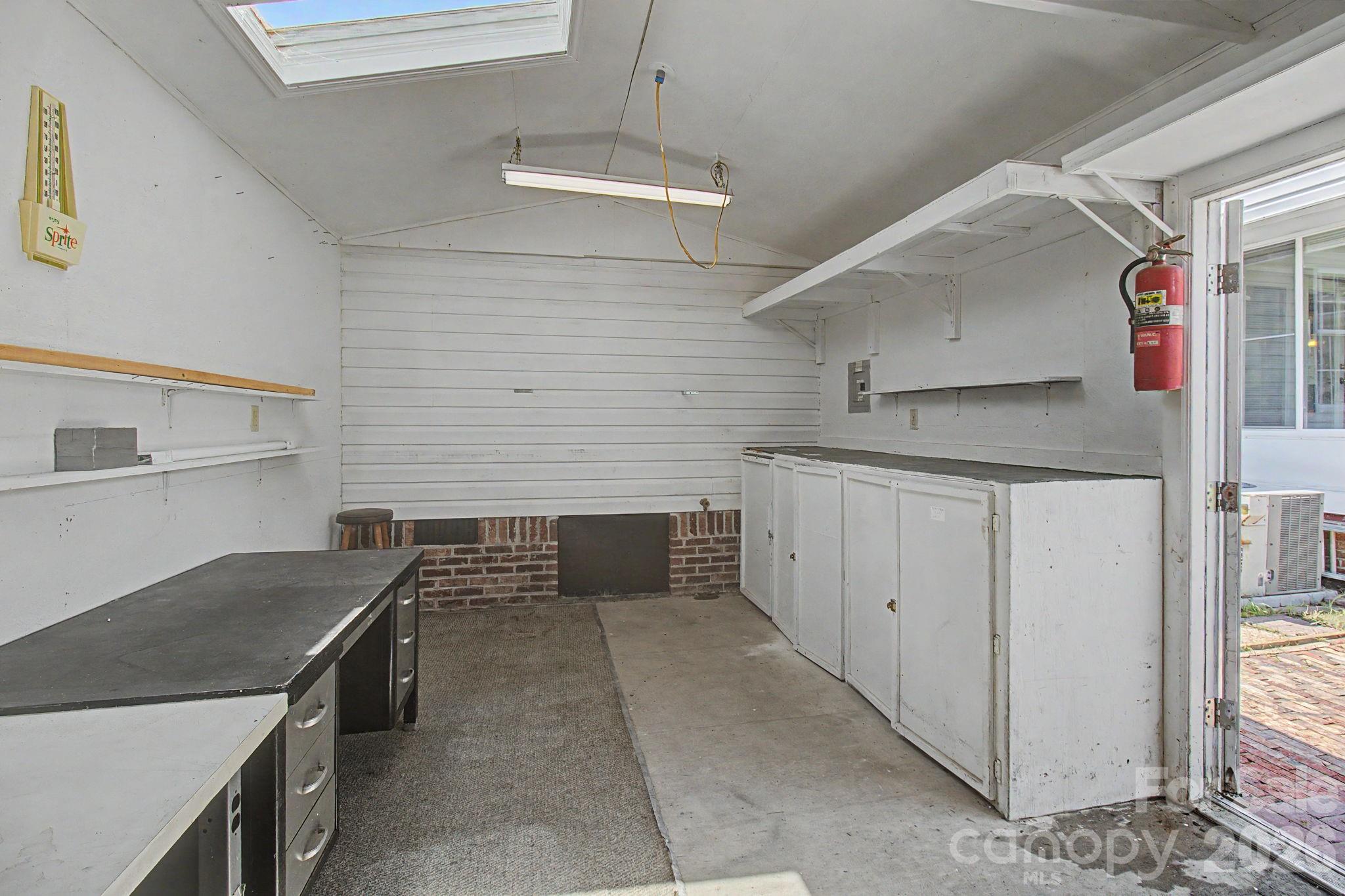 The attached workshop with built-in shelving - 204 Red Birch Court, Hendersonville