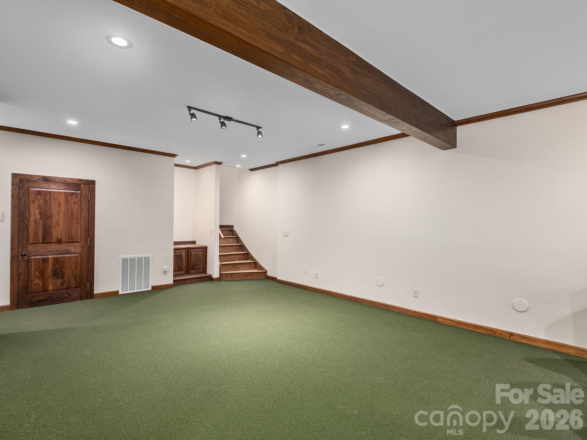 Golf 'carpet' is not adhered to the floor and can easily be removed if buyer prefers. Original tile still exists under 'carpet' - 248 Wisdom Cove Road, Flat Rock