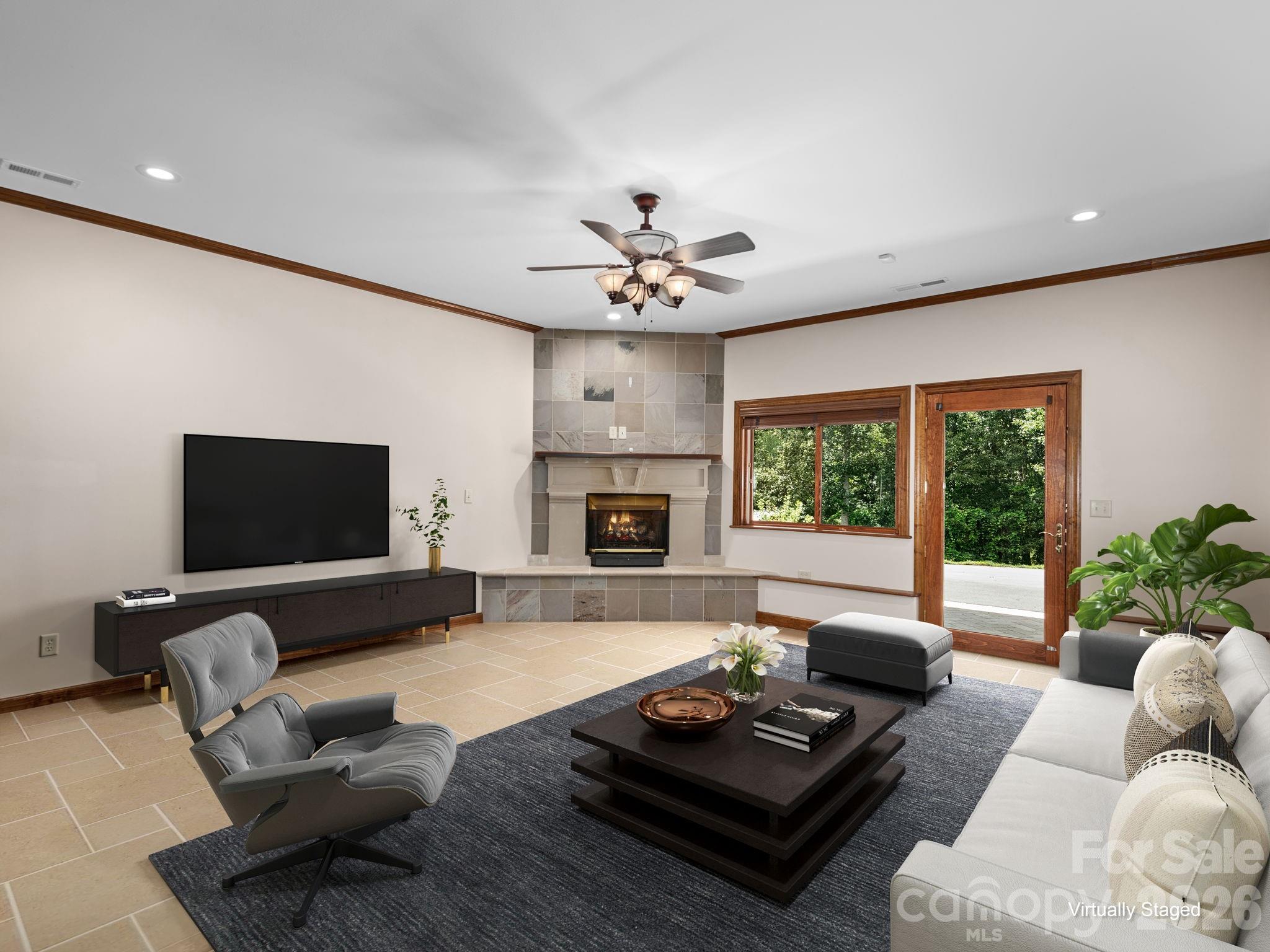 Virtually staged living space showing similar tile under the golf carpet. Lower level walk out access. - 248 Wisdom Cove Road, Flat Rock