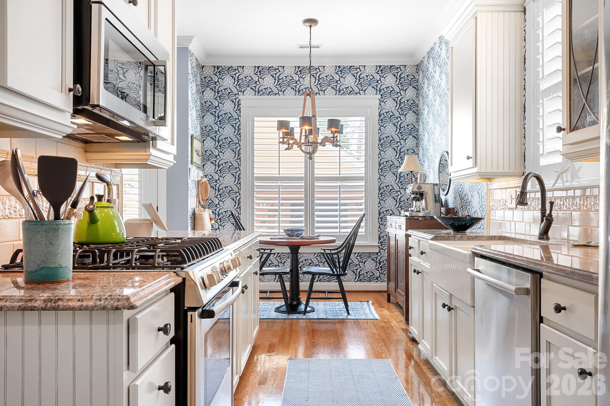 Classic galley style kitchen has been updated with newer cabinets and gorgeous custom tiles. Kitchen is semi open concept to the living space. - 17525 Calverton Road, Huntersville