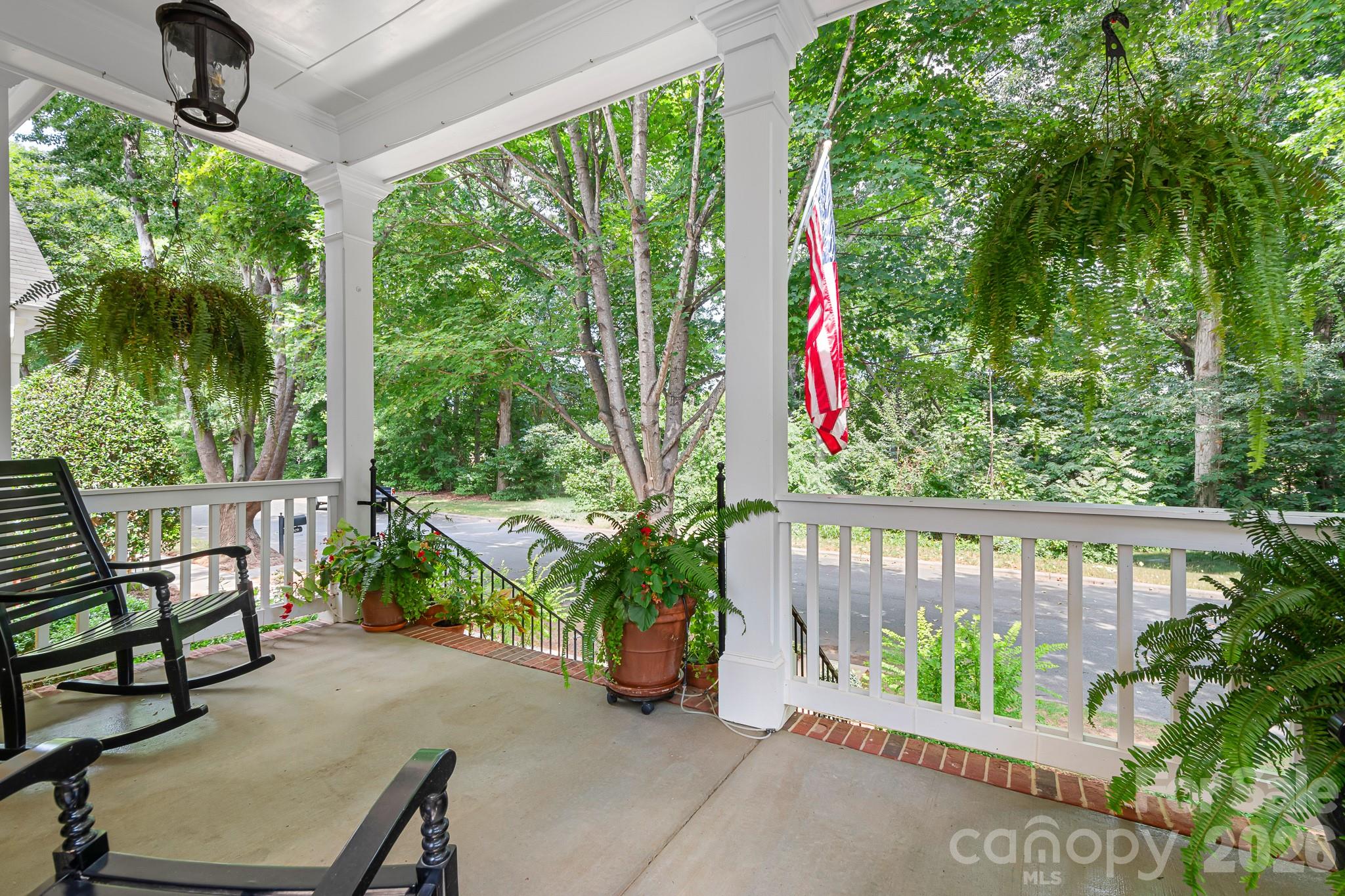 Located in the center of the community on a wide and quiet street overlooking trees. This front porch is a peaceful retreat. - 17525 Calverton Road, Huntersville