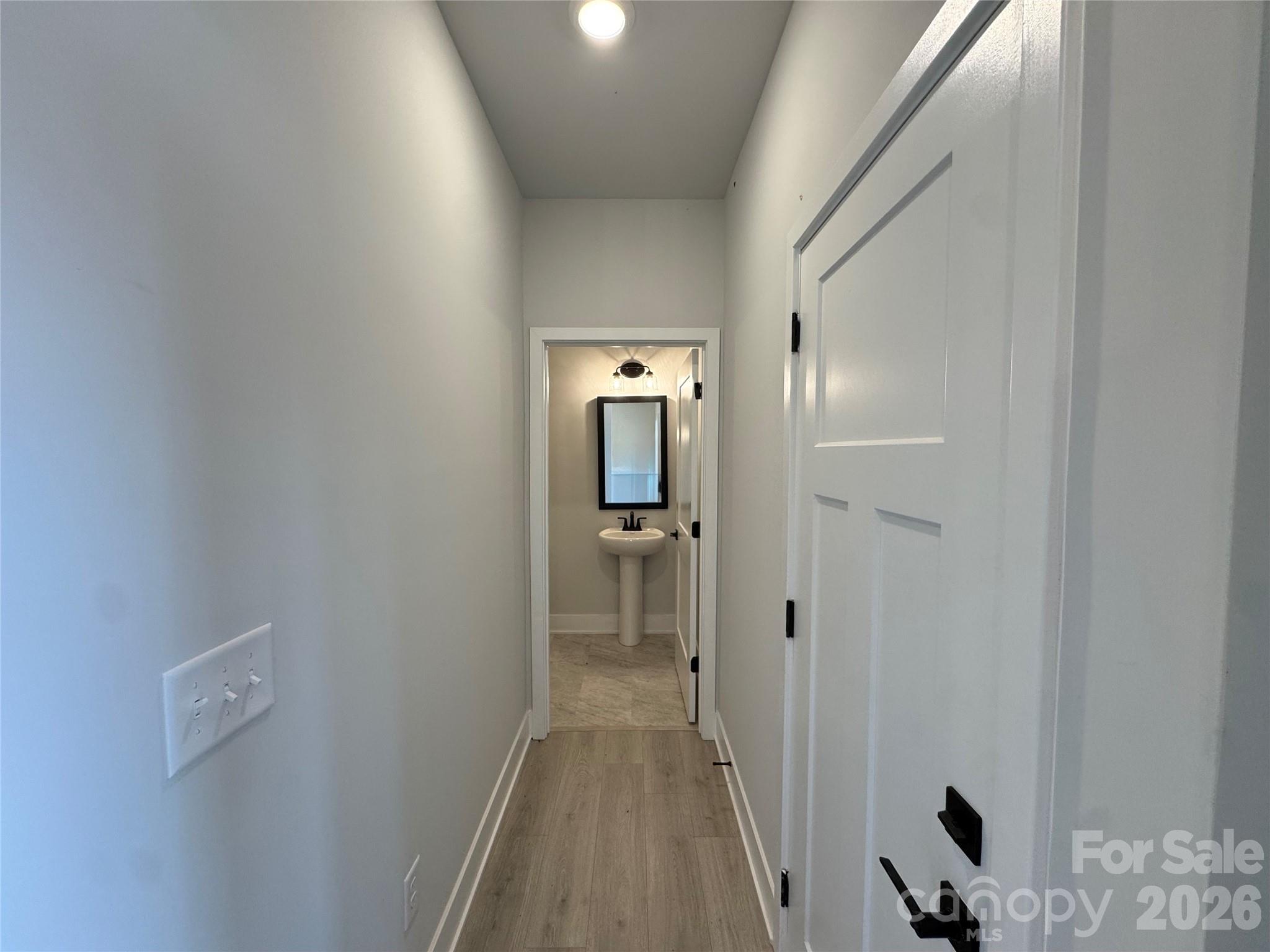 Hallway to half bath on 1st floor - 133 Kerr Walk Drive, Statesville