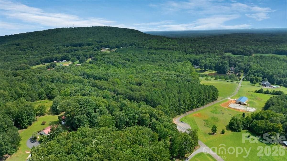 Aerial view showing Lot 1’s quiet cul-de-sac setting along Fishermans Lane and the surrounding wooded countryside. - 01 Fishermans Lane, Maiden