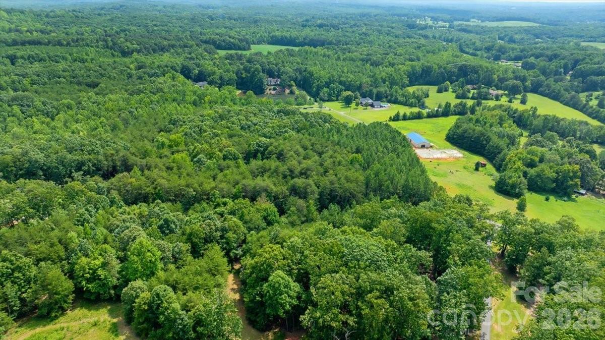 Wide aerial view of the wooded setting and surrounding countryside. - 01 Fishermans Lane, Maiden