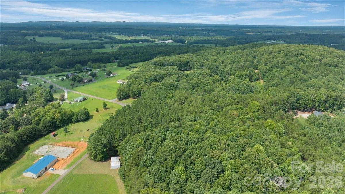 Aerial perspective showing the wooded setting and depth of the property near the end of Fishermans Lane. - 01 Fishermans Lane, Maiden