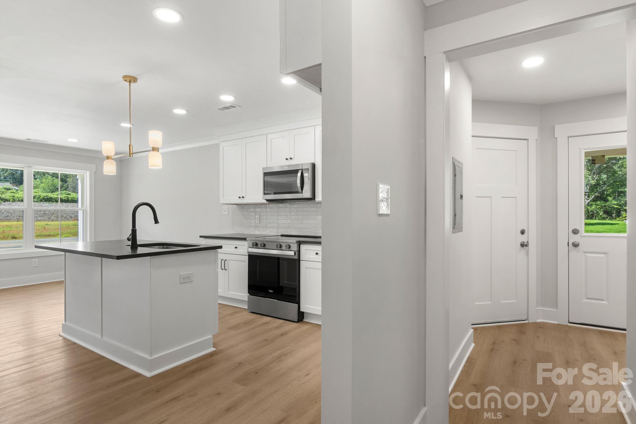 Hall to back door, garage access door and laundry room - 145 McCorkle Street, York