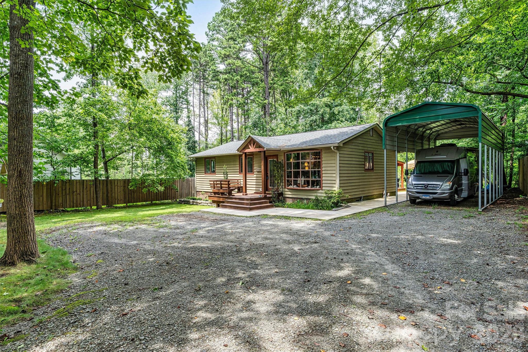 Front elevation featuring an oversized carport for your RV. 7697 Katherine Drive - 7697 Katherine Drive, Denver