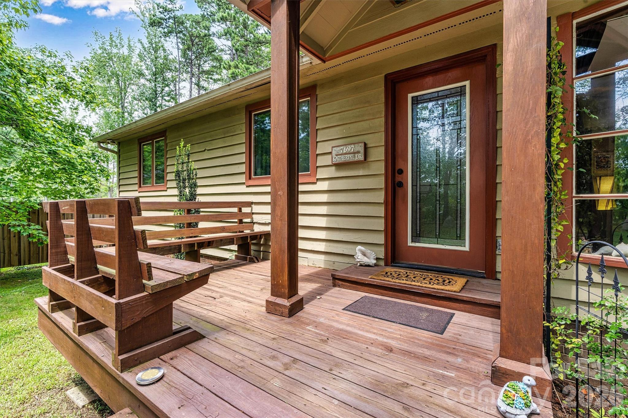 Welcoming front door with benches to enjoy the birds and small woodland creatures as you sip your coffee. 7697 Katherine Drive - 7697 Katherine Drive, Denver