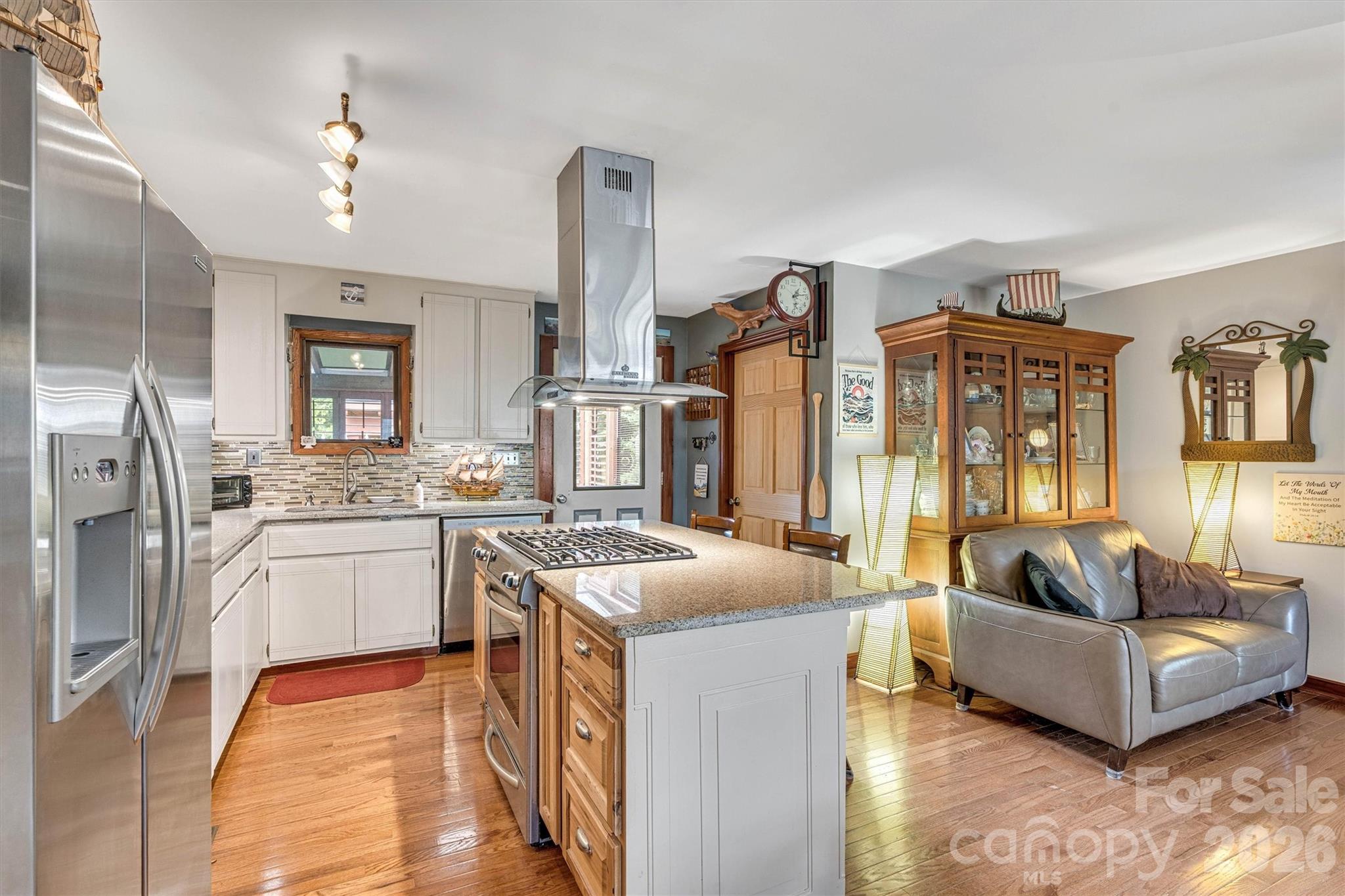 Kitchen features a Island range hood and gas stove. 7697 Katherine Drive - 7697 Katherine Drive, Denver