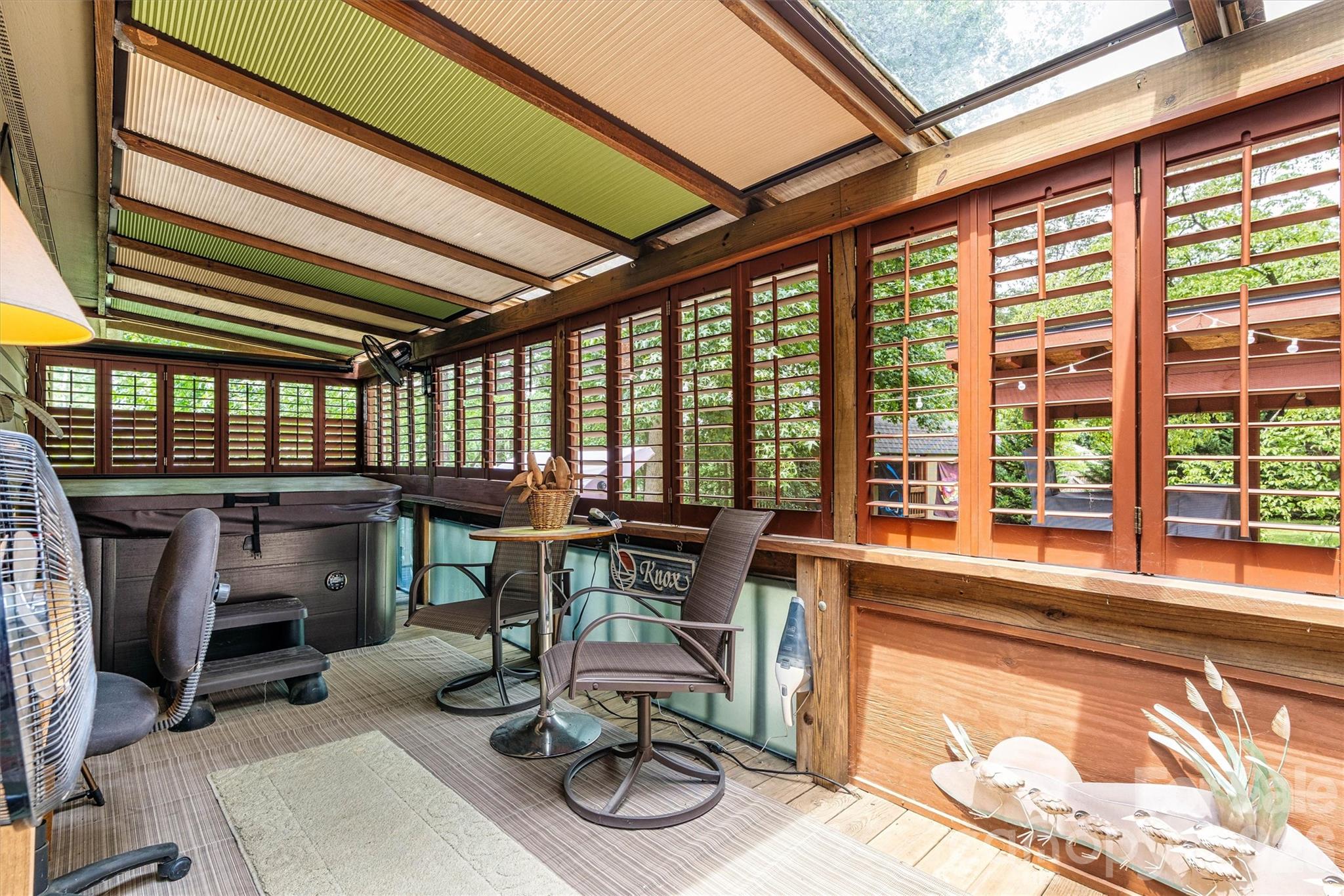 Screened patio in the backyard with a hot tub that will remain. 7697 Katherine Drive - 7697 Katherine Drive, Denver