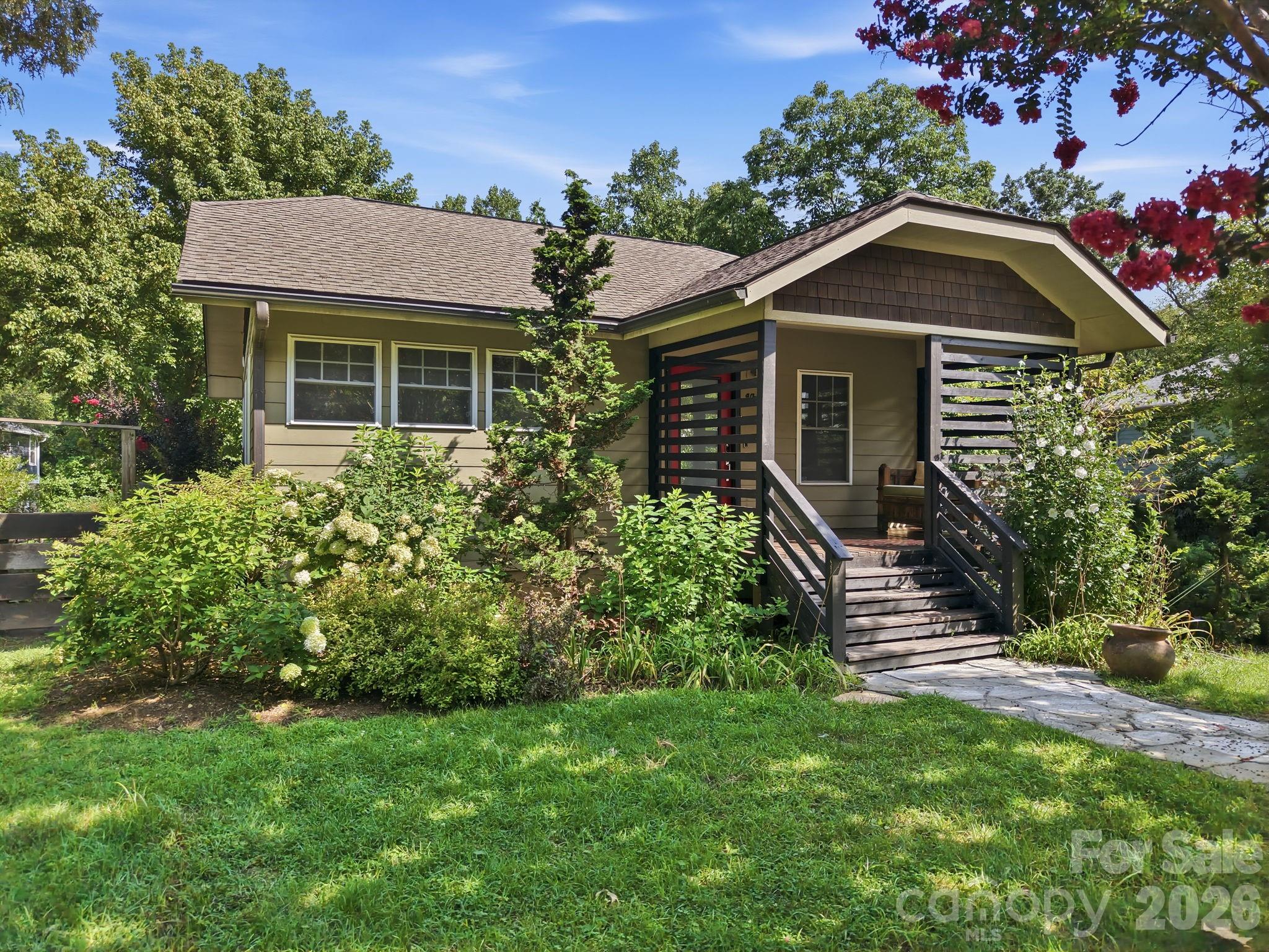 Inviting front exterior featuring an entryway and meticulously maintained mature landscaping. - 146 Courtland Avenue, Asheville