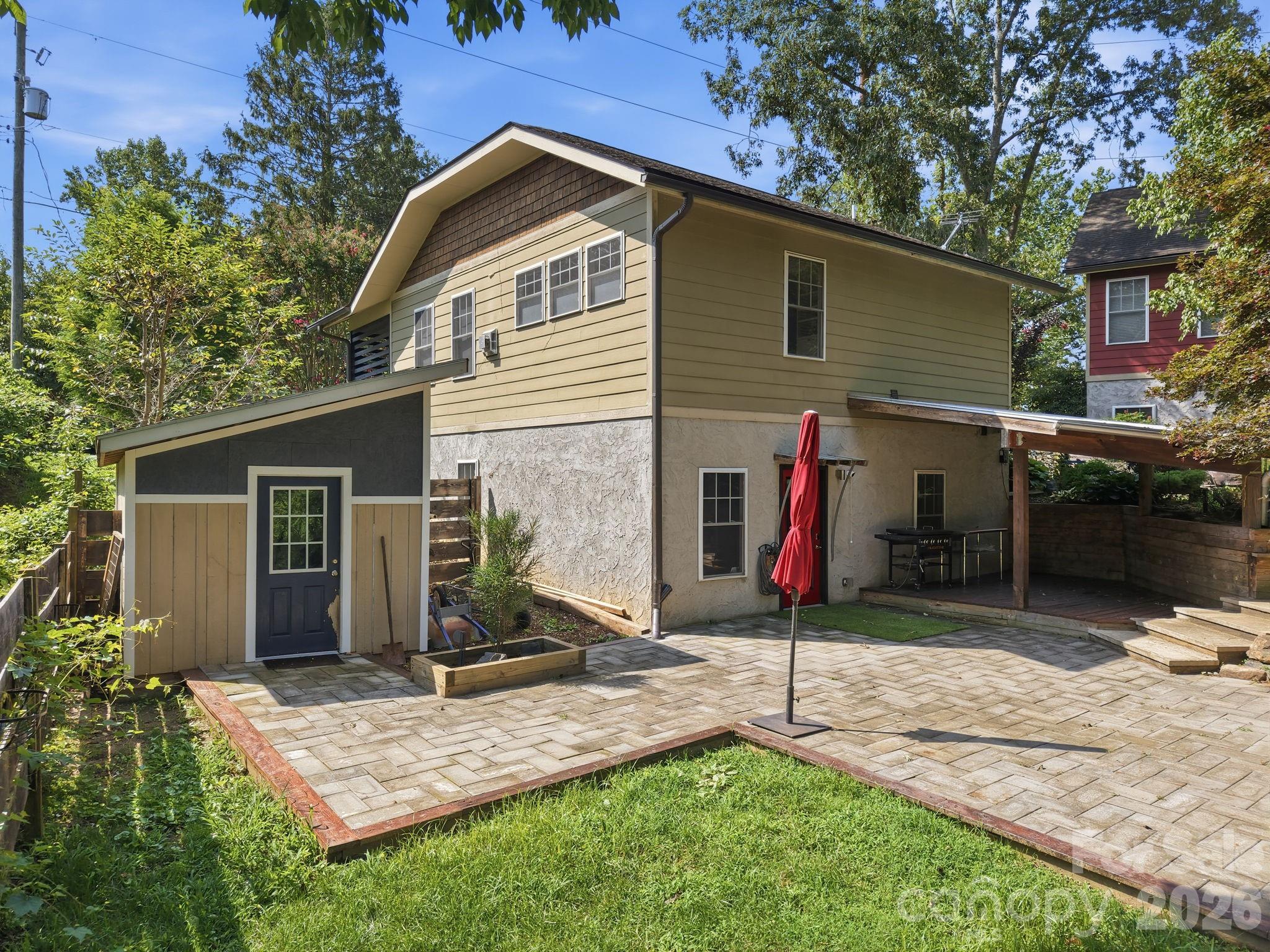 Back entry showing the yard and the newly refurbished outbuilding. - 146 Courtland Avenue, Asheville