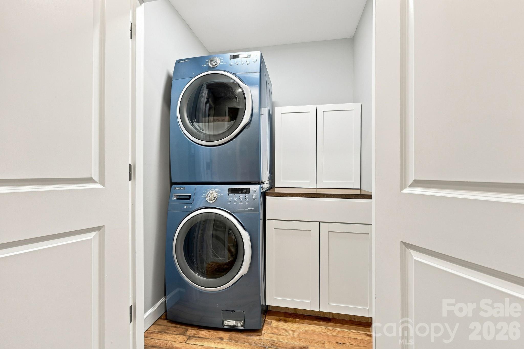 Main level laundry room featuring built-in storage cabinets. - 146 Courtland Avenue, Asheville