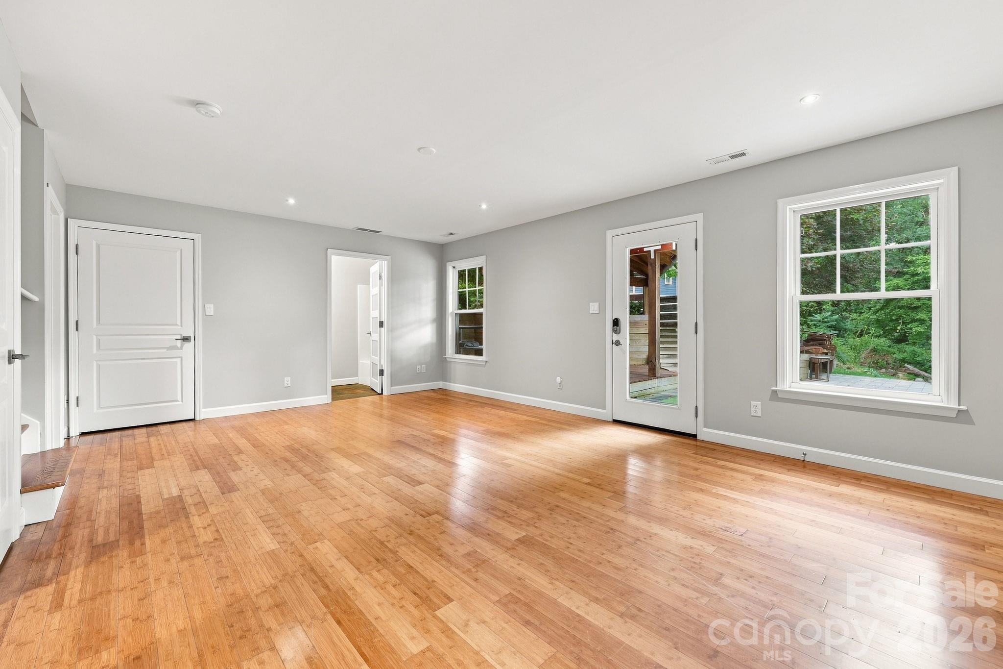 Lower level family room and flexible living space featuring durable bamboo flooring. - 146 Courtland Avenue, Asheville