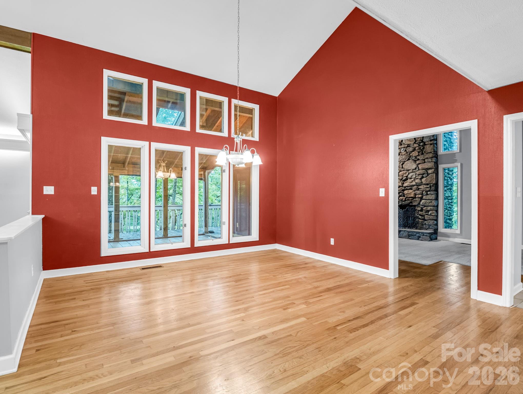 Dining Room overlooks covered porch area; 2 doors on right side: left door leads Family Room; right door leads to Kitchen - 10 Chestnut Ridge Road, Mills River