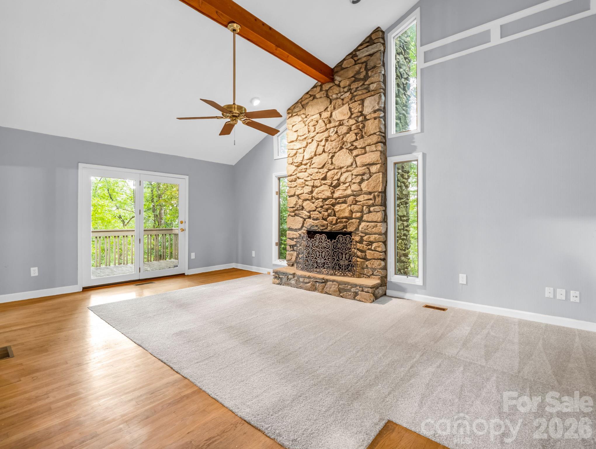Den with stone fireplace off of Kitchen & Dining Room, door to covered patio & open Deck - 10 Chestnut Ridge Road, Mills River