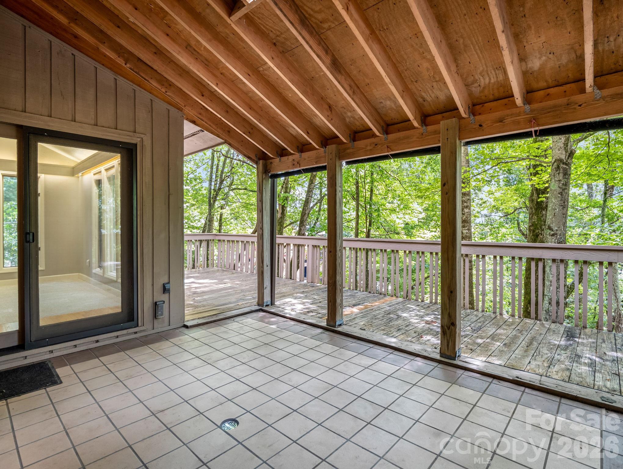 MAIN LEVEL: Dining room looks out into the covered porch area, which is situated between Family Room & Living Room, - 10 Chestnut Ridge Road, Mills River
