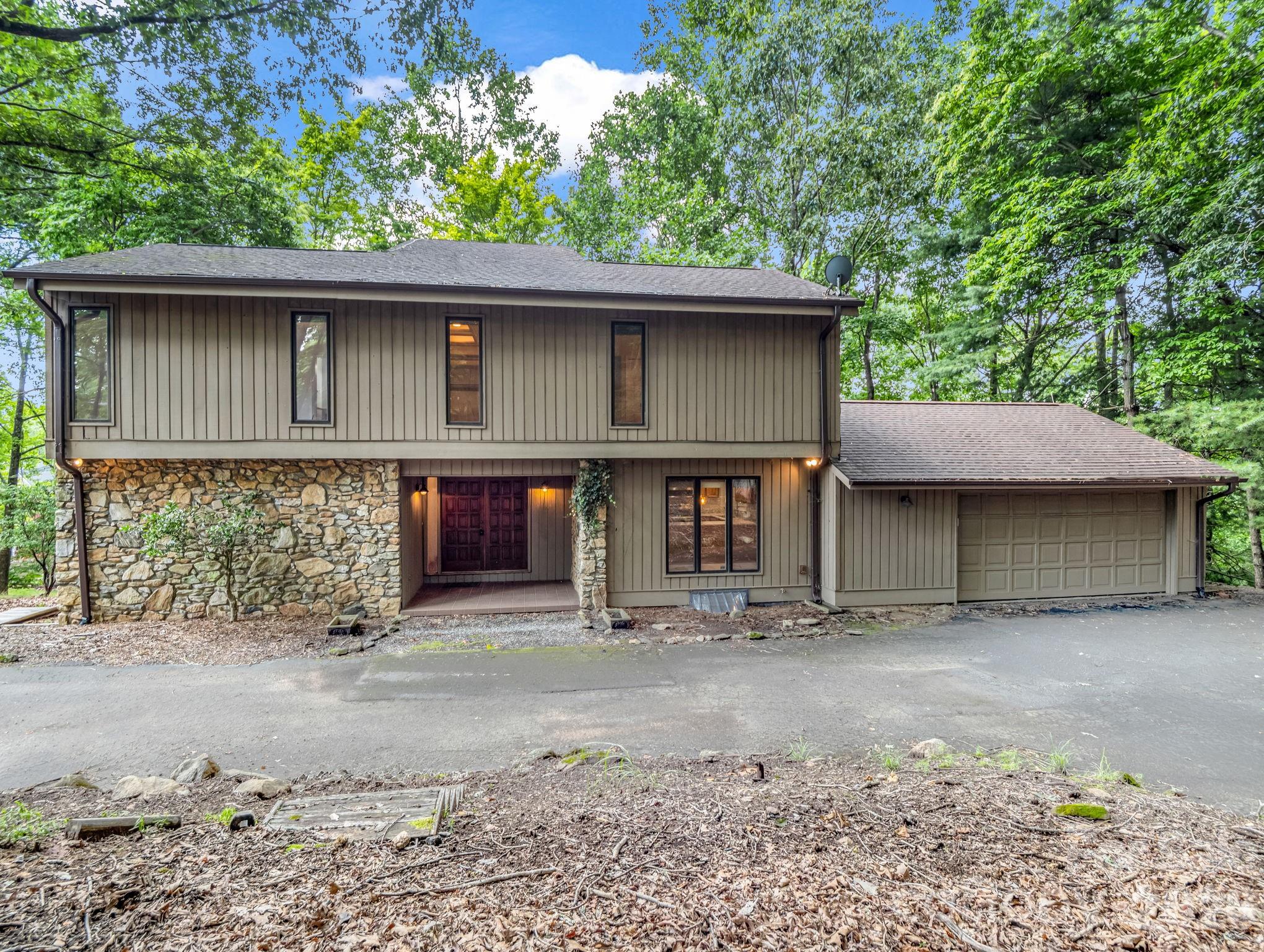 Striking stone facade, grand covered entrance with double solid wood doors lead inside to proper foyer. - 10 Chestnut Ridge Road, Mills River