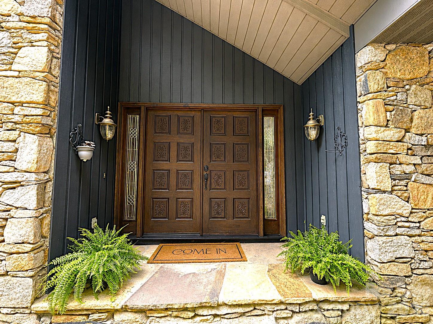 Carved detail in this front door make it stand out above the rest. - 1105 High Vista Drive, Mills River