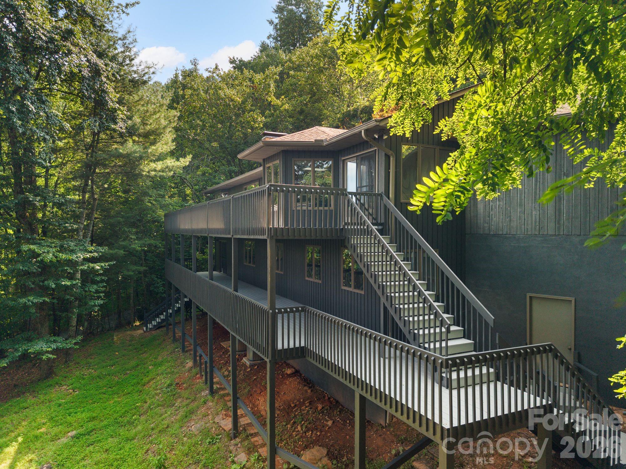 Decks for days to catch those cool mountain breezes with a cup o' whatever you like. - 1105 High Vista Drive, Mills River